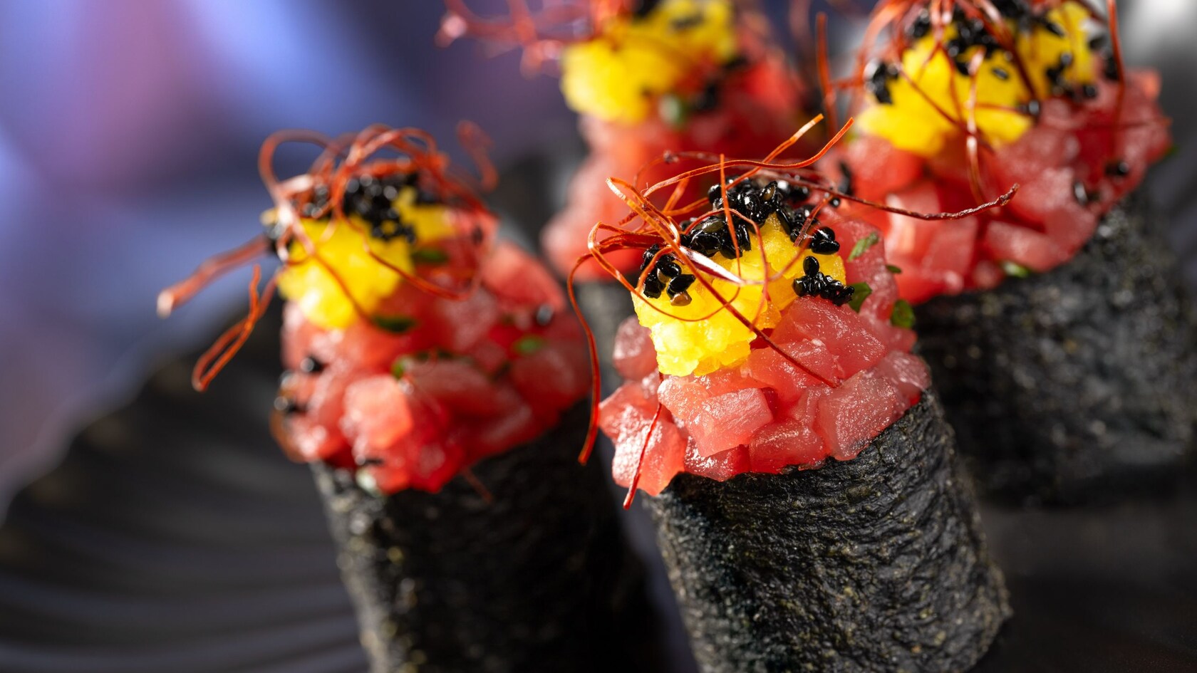 A dish featuring ahi tuna and black sesame seeds 