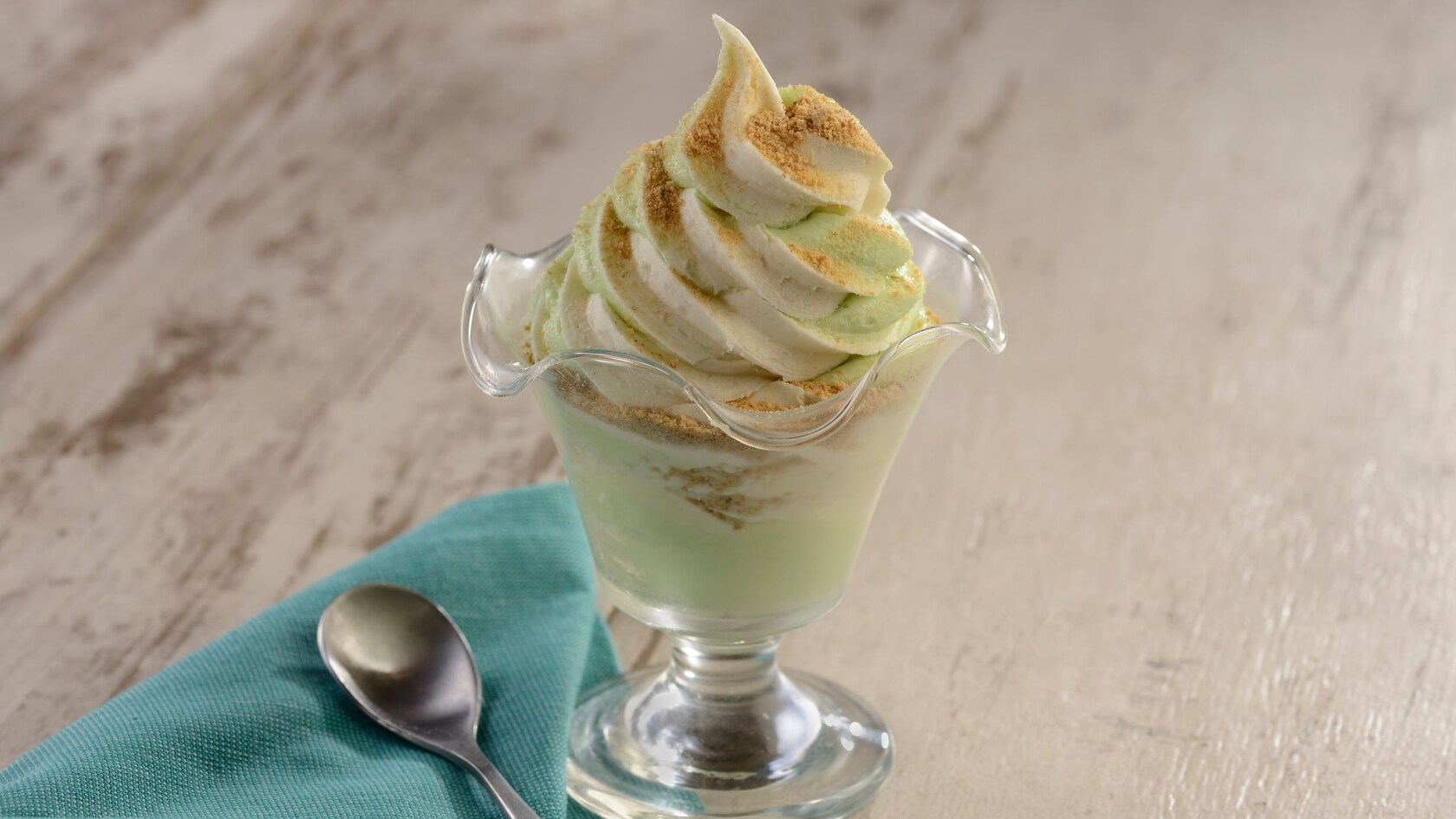 A dish of key lime DOLE Whip, a napkin and a spoon