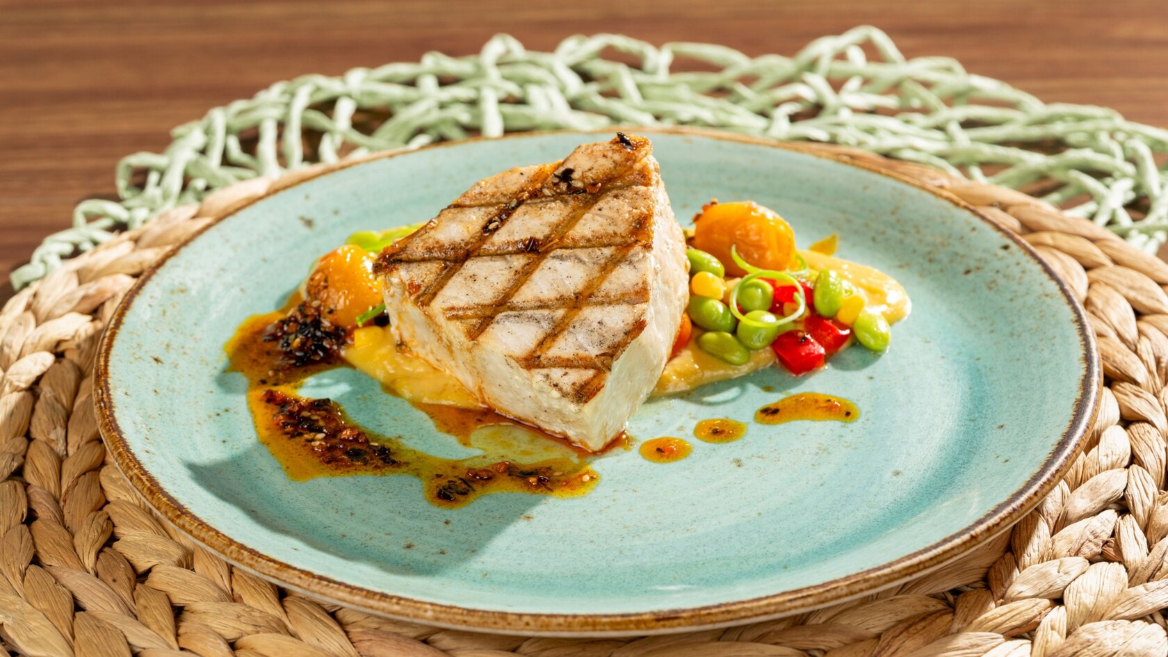Grilled fish fillet with edamame, roasted tomatoes and citrus sauce