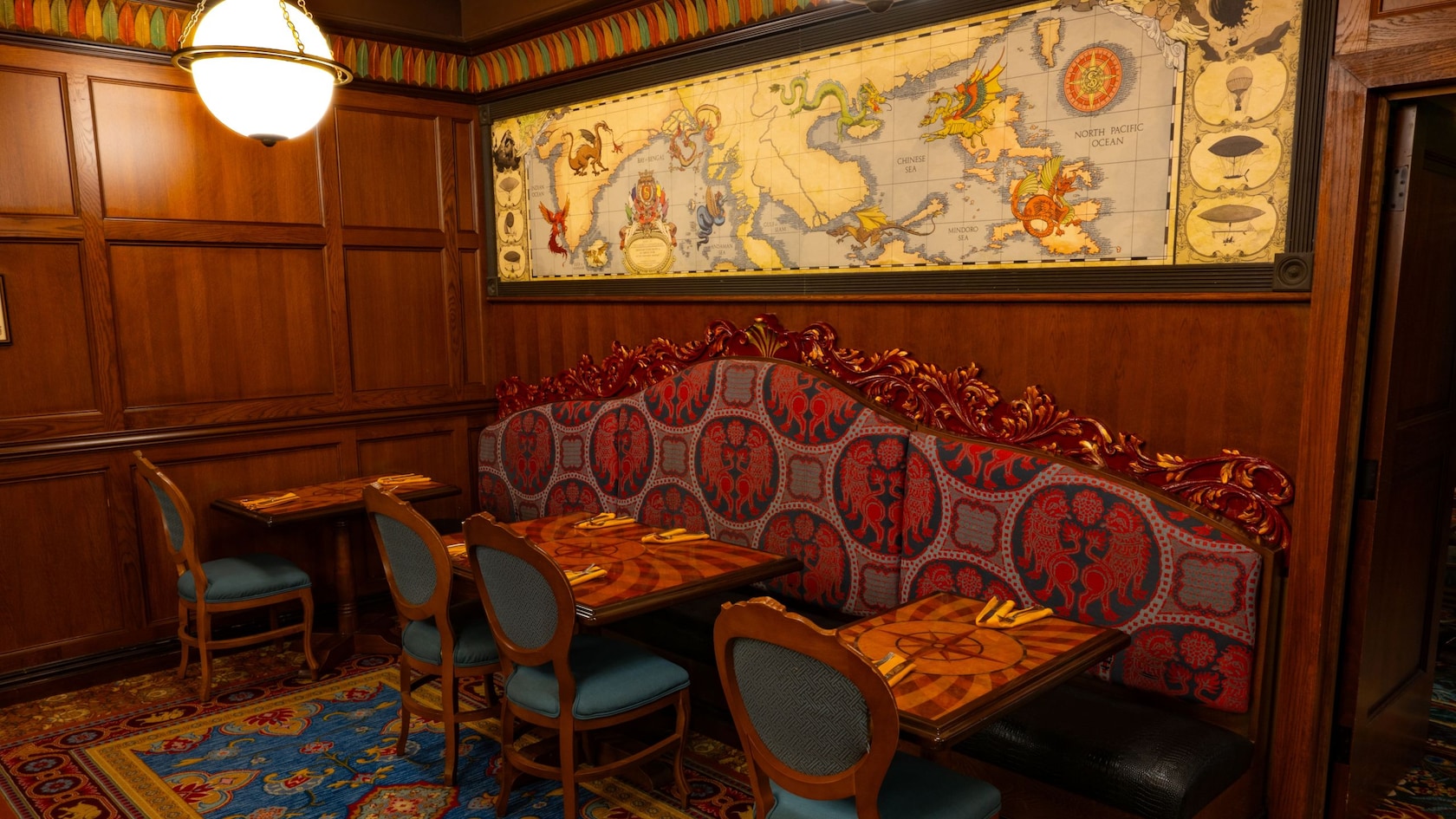 A dining room decorated with a large map at the Jungle Navigation Company Limited Skipper Canteen