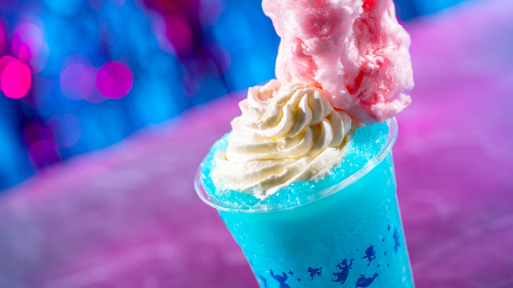 An Electric Slushy drink topped with whipped cream and cotton candy from FØØD by Swedish Chef