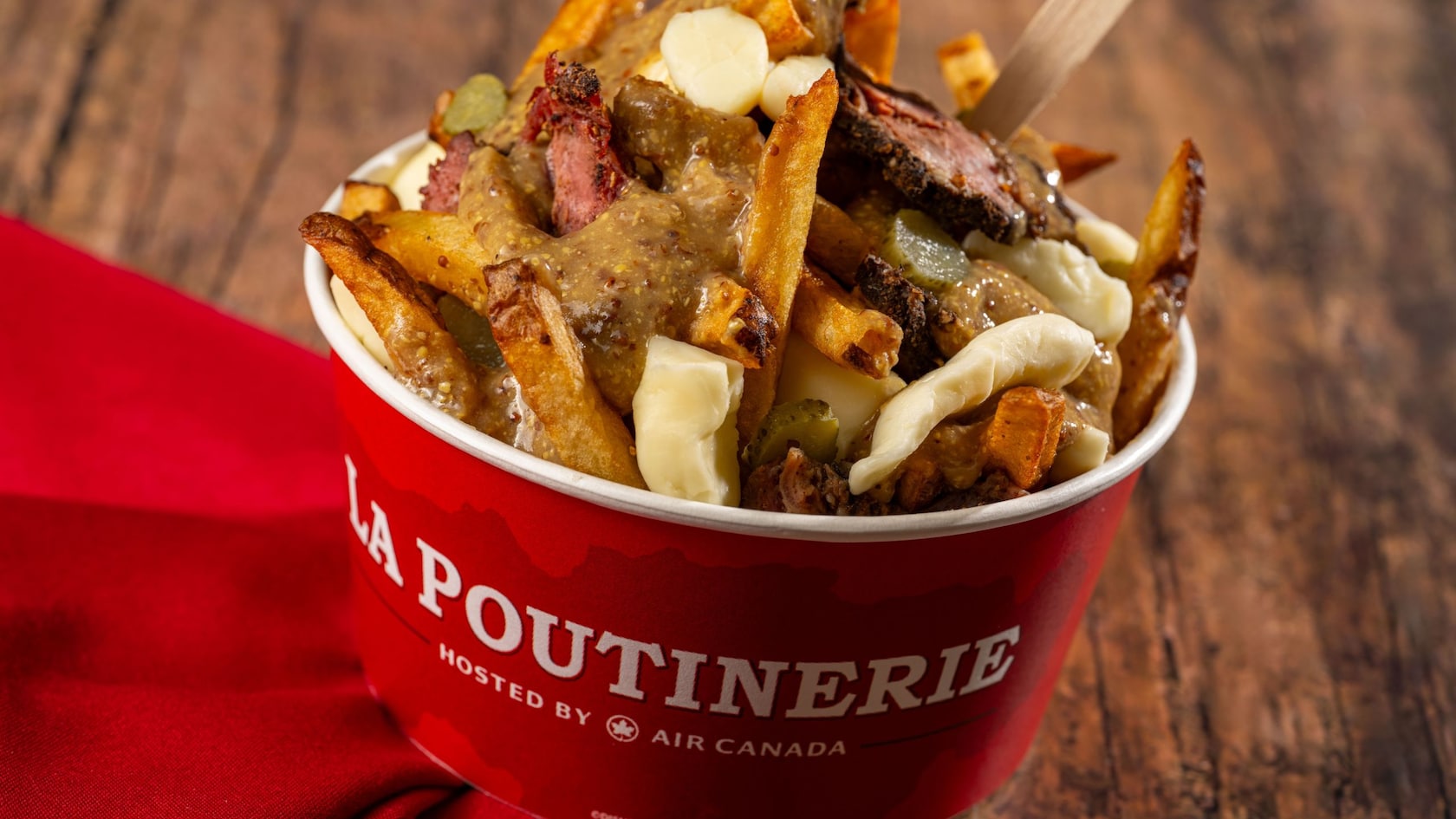 Montreal Viande Fumée poutine with french fries, cheese curds, smoked meat, pickles, and mustard gravy