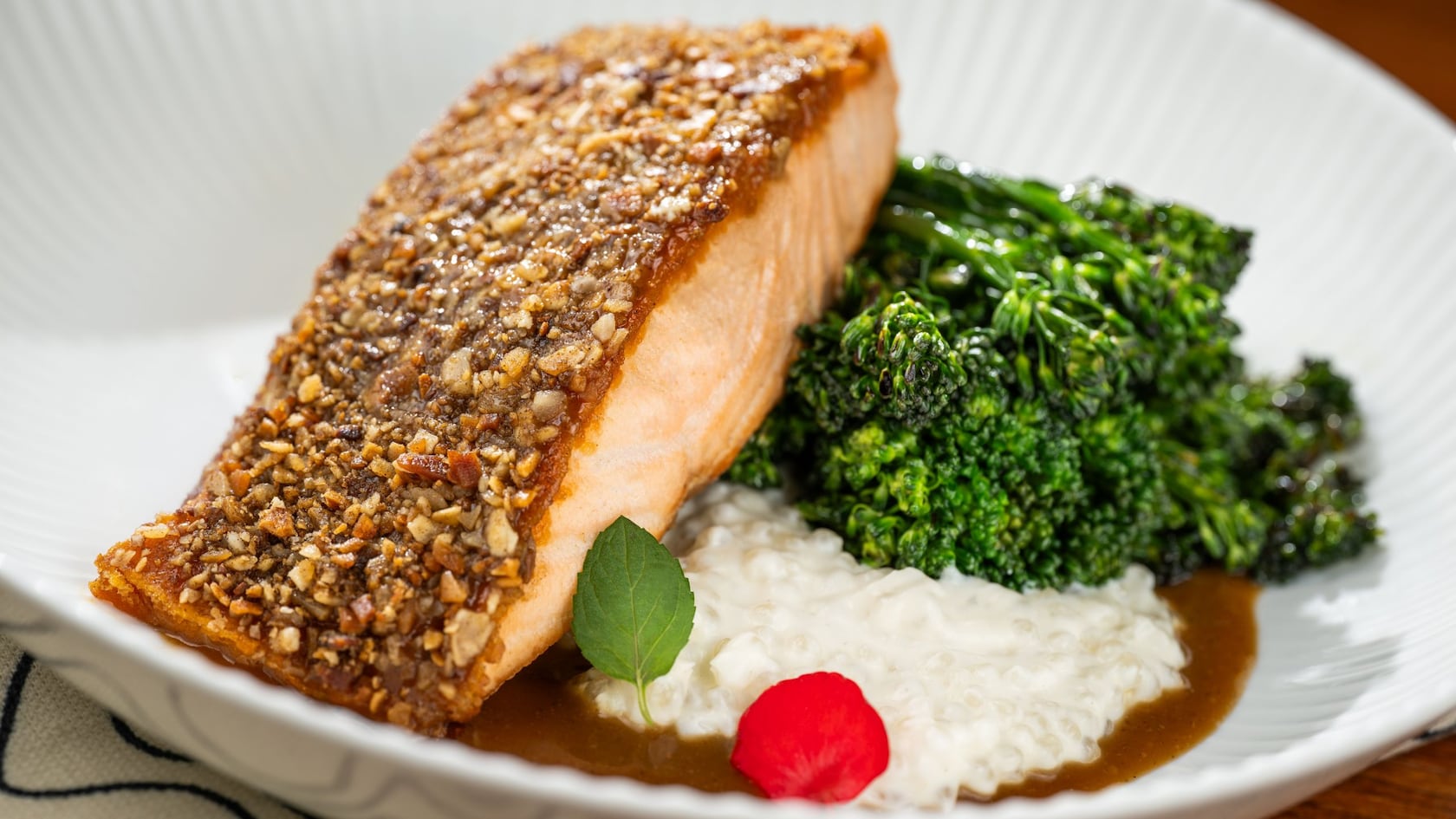 An almond crusted salmon filet paired with broccolini, celery root tapioca and adobo sauce