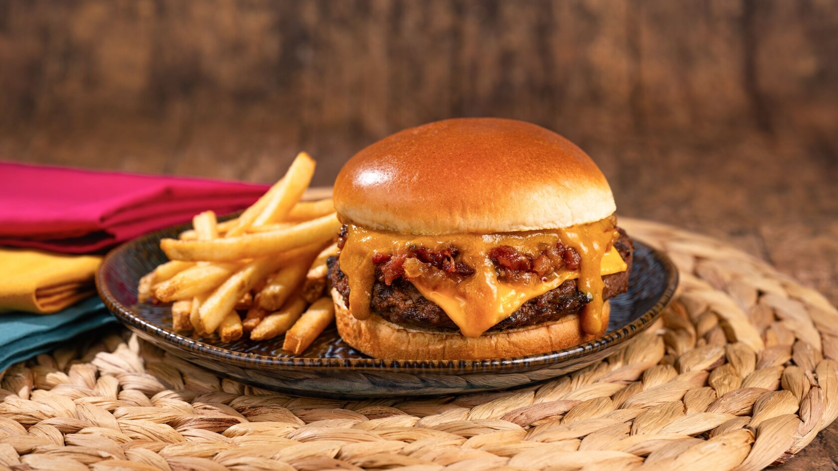 A cheeseburger with 2 beef patties, cheese, bacon and a side of fries