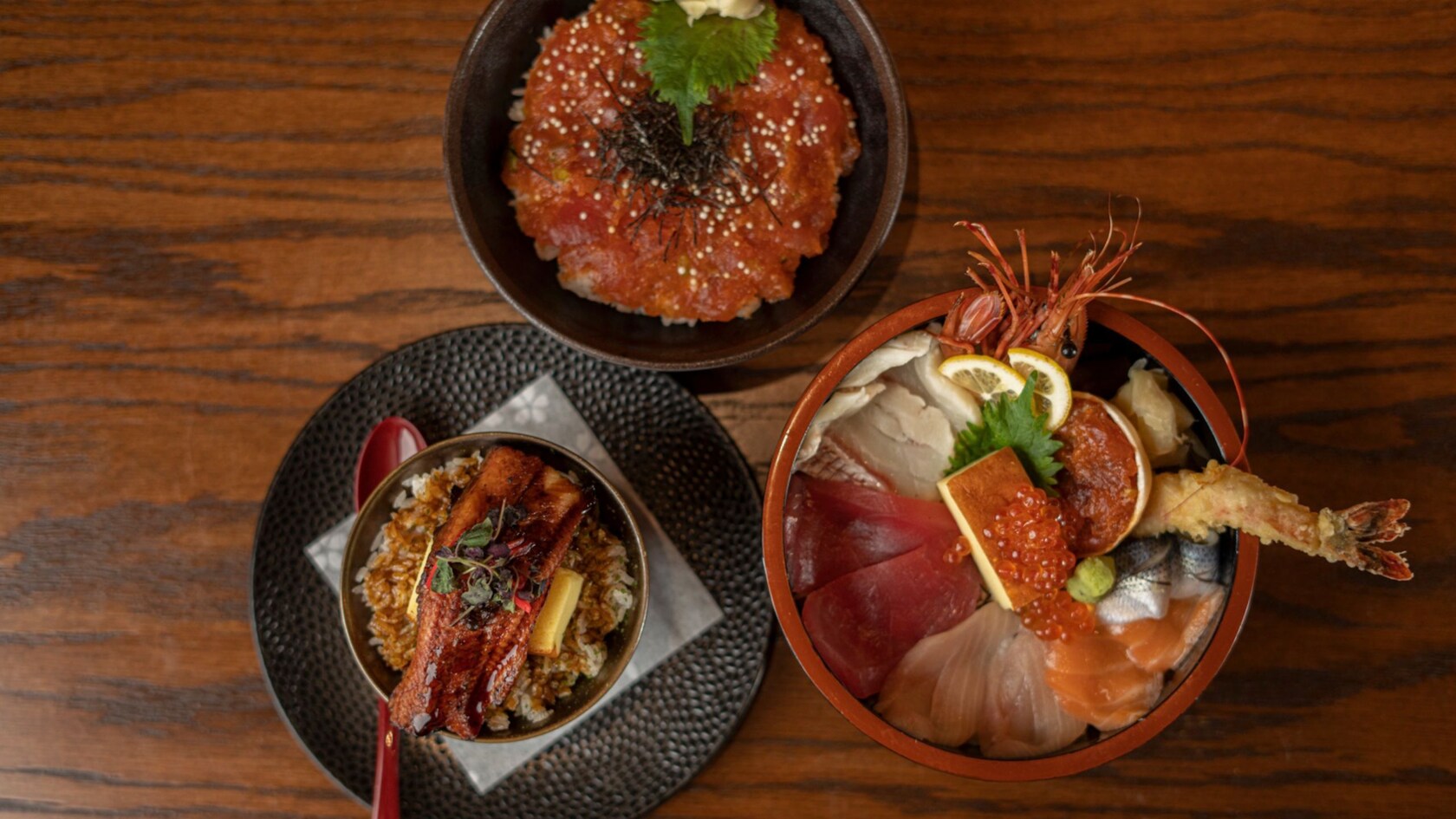 Three bowls containing Japanese rice dishes