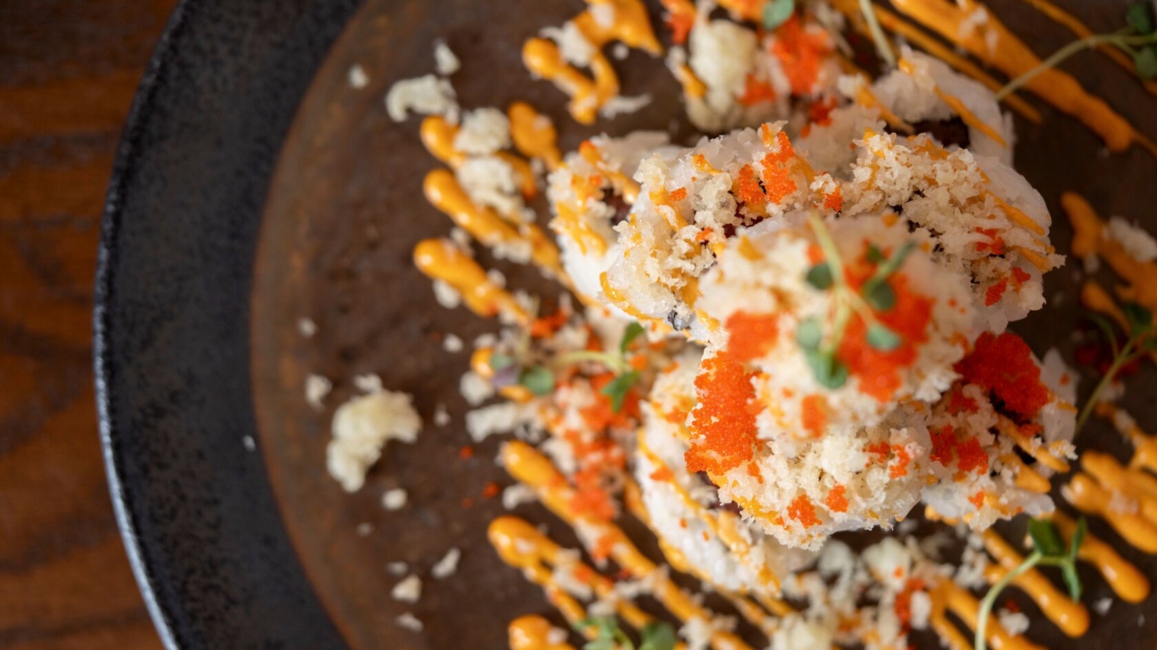 A plate holding a spicy crunch roll