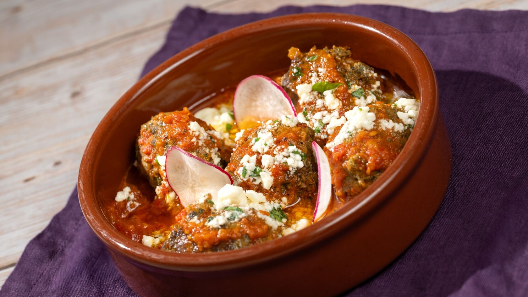 Spiced Lamb Kefta topped with feta cheese and tomato sauce at Spice Road Table