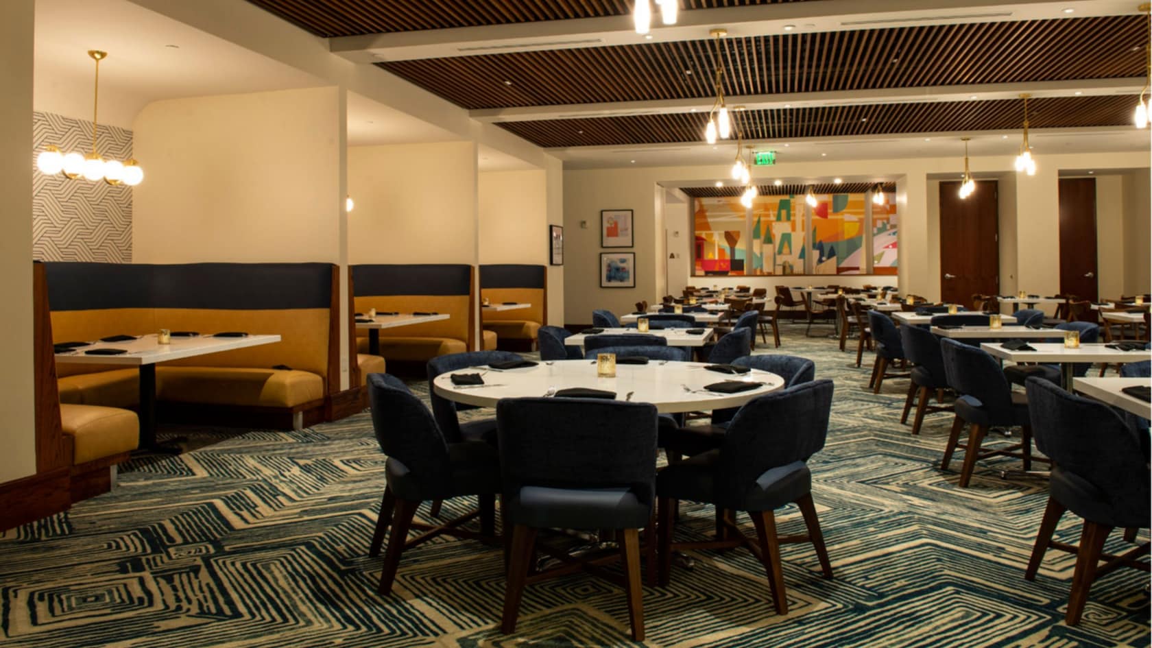 A dining room at Steakhouse 71 with table and booth seating