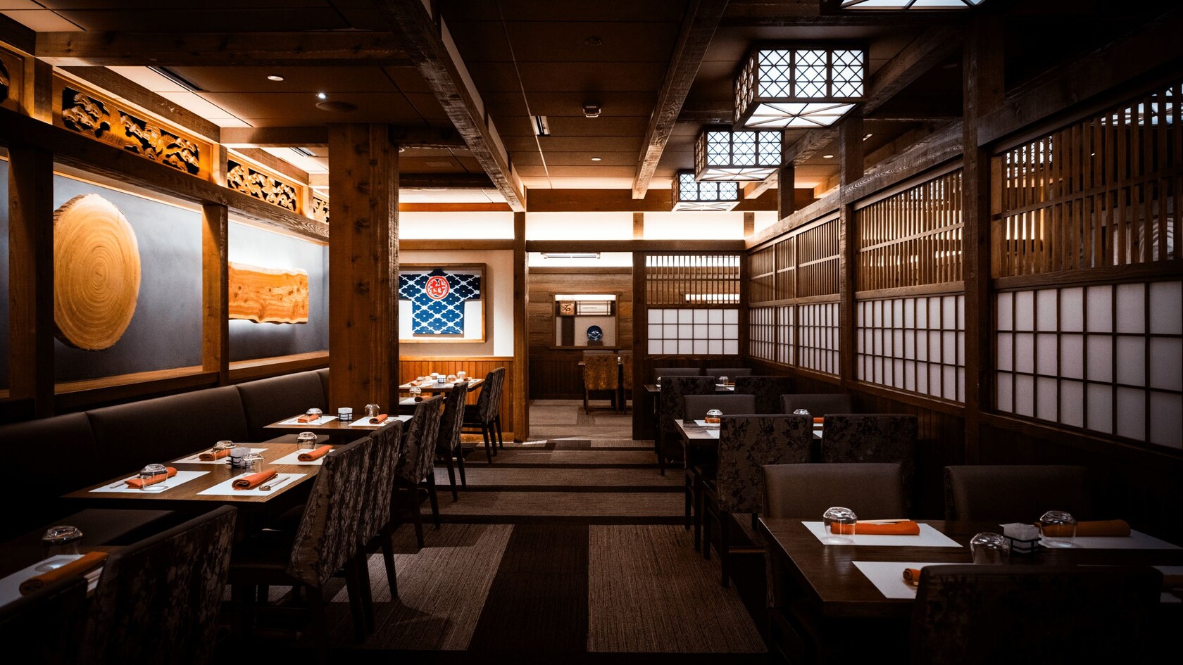 Tables, chairs and place settings inside of a pagoda at Takumi Tei