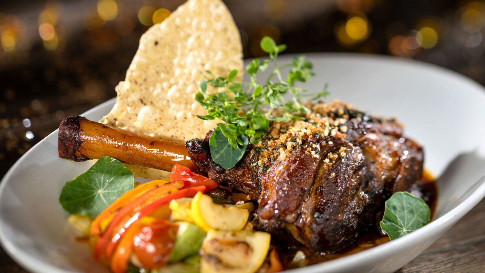 Lamb shank served with veggies on a plate