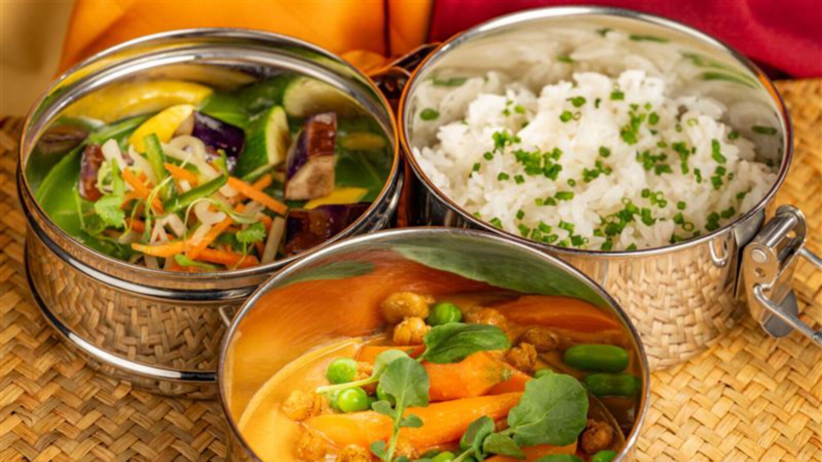 Stainless steel containers with rice, vegetable stir-fry and curry at Tiffins Restaurant
