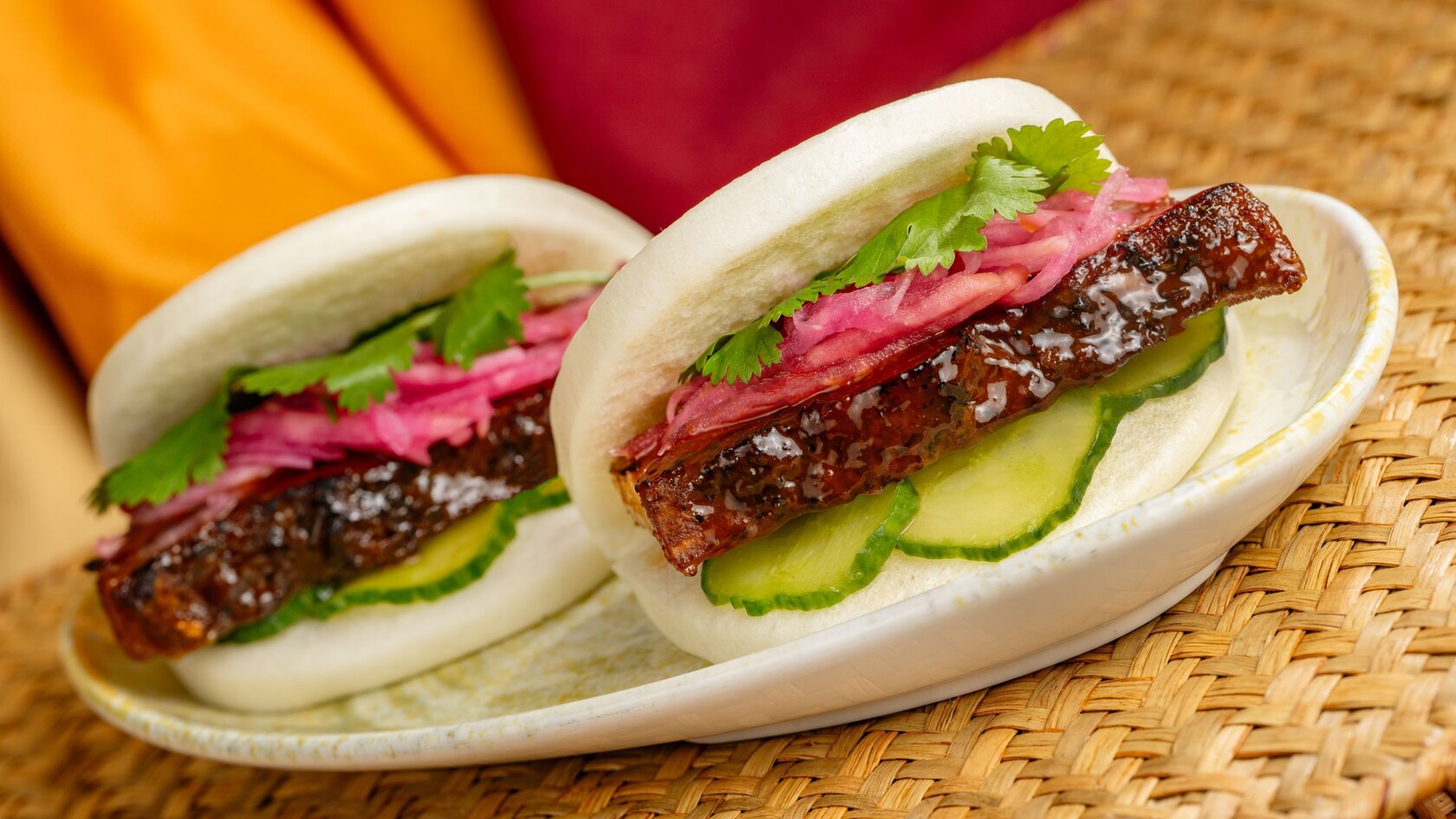 Steamed bao buns filled with pork belly, cucumbers, pickled vegetables and cilantro at Tiffins Restaurant