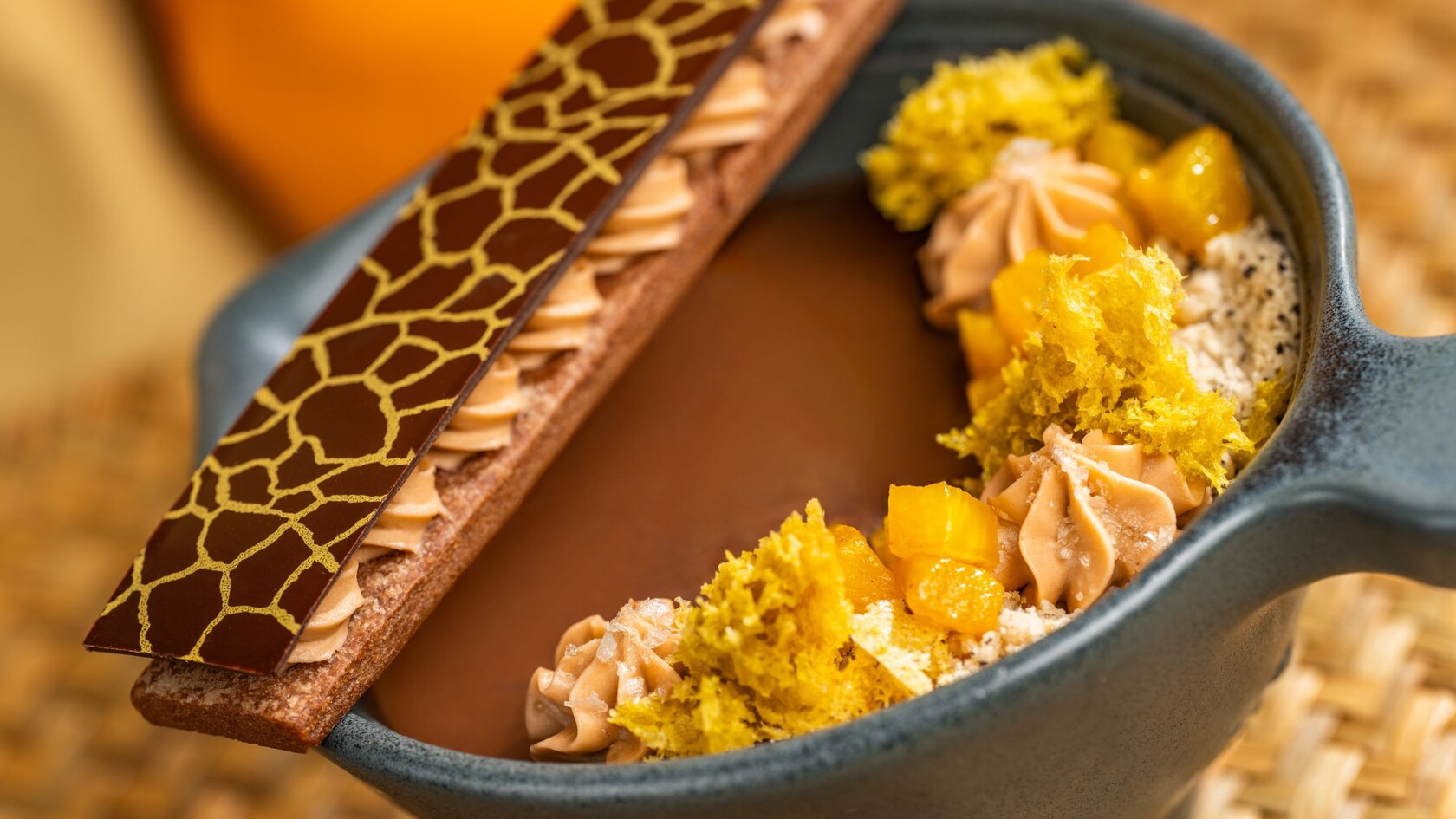 A chocolate dessert with piped cream rosettes and a chocolate accent on top at Tiffins Restaurant