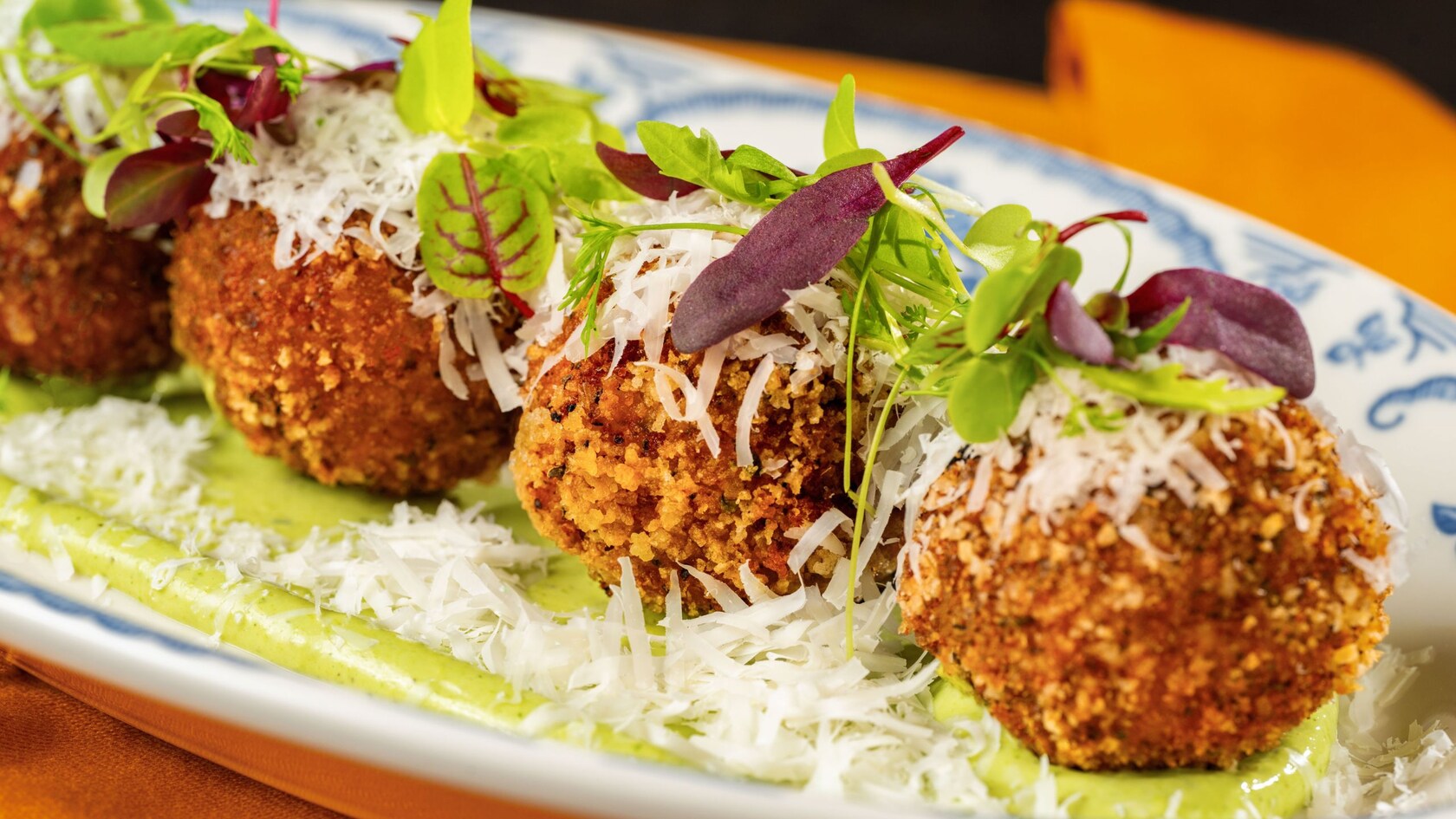 A plate with 4 arancini from Trattoria al Forno in Disney’s Boardwalk