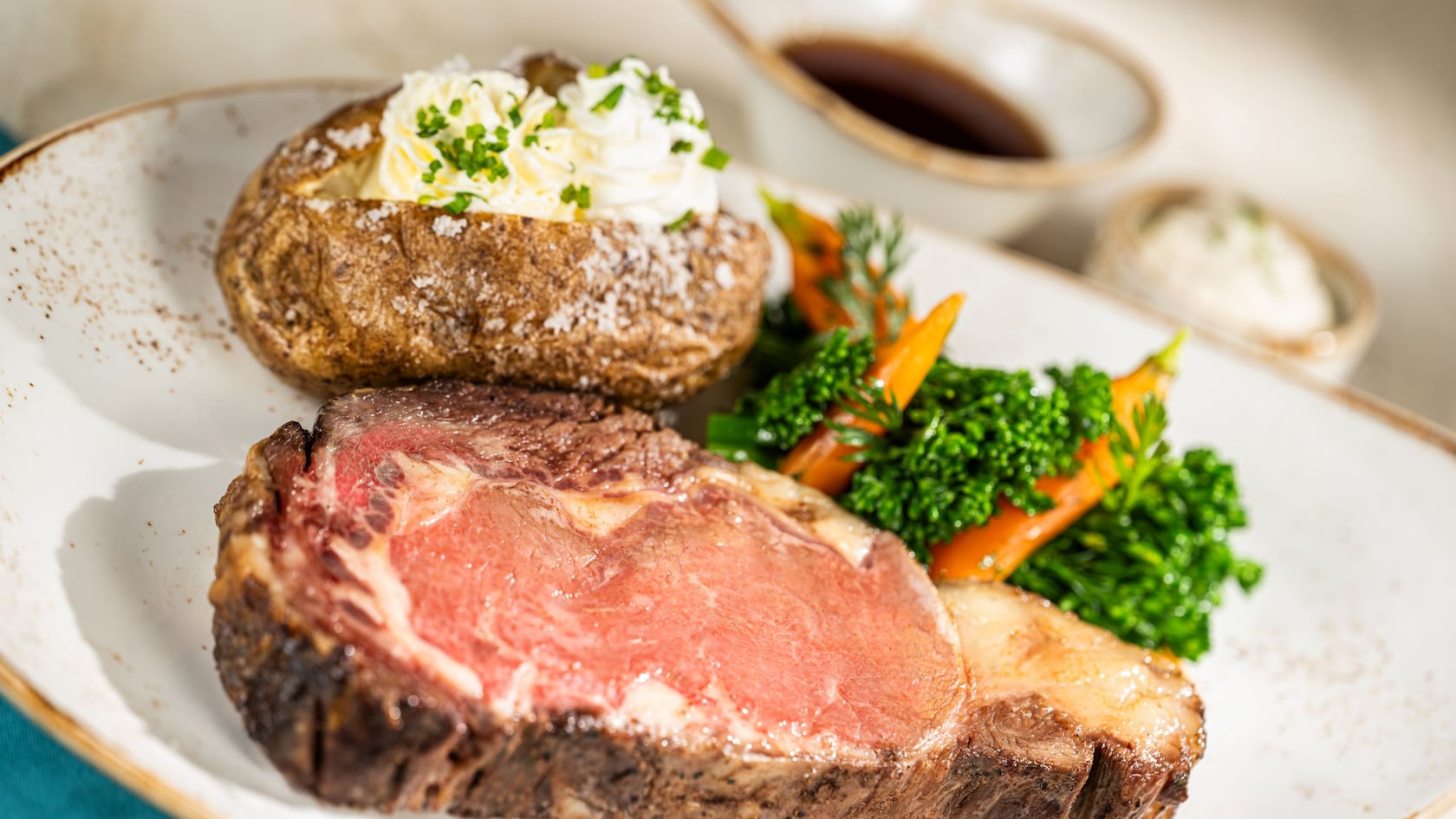Slow-Roasted Prime Rib served with a baked potato at The Turf Club Bar & Grill