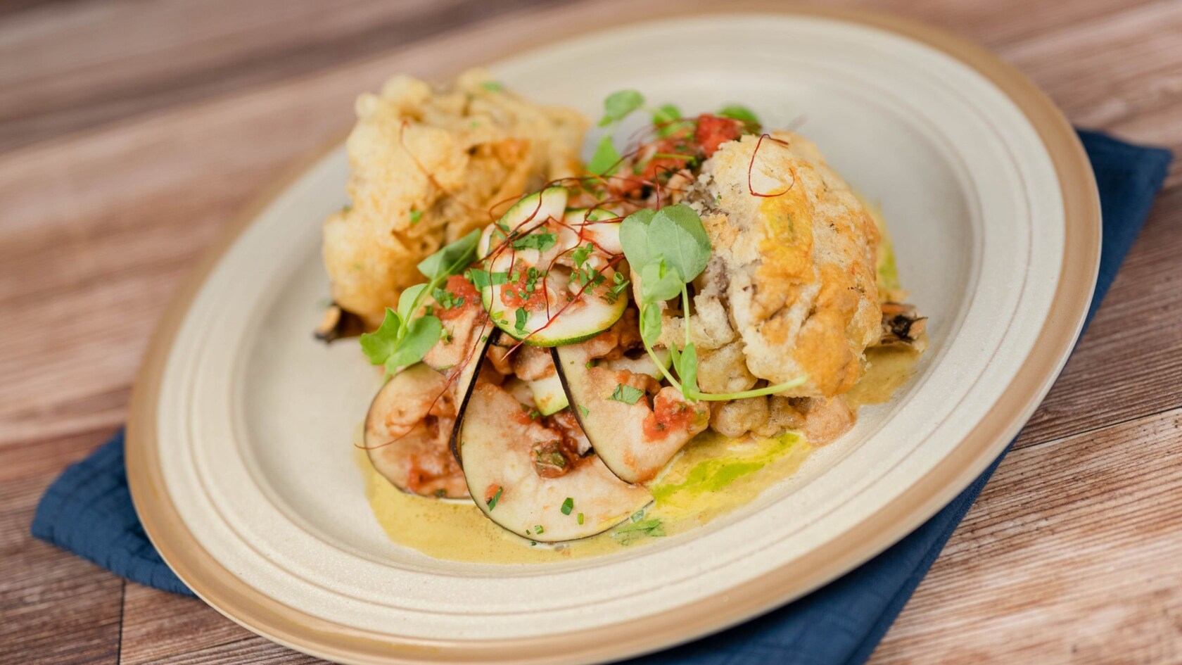 A dish with Tempura Fried Hen of the Wood Mushrooms from The Turf Club Bar & Grill