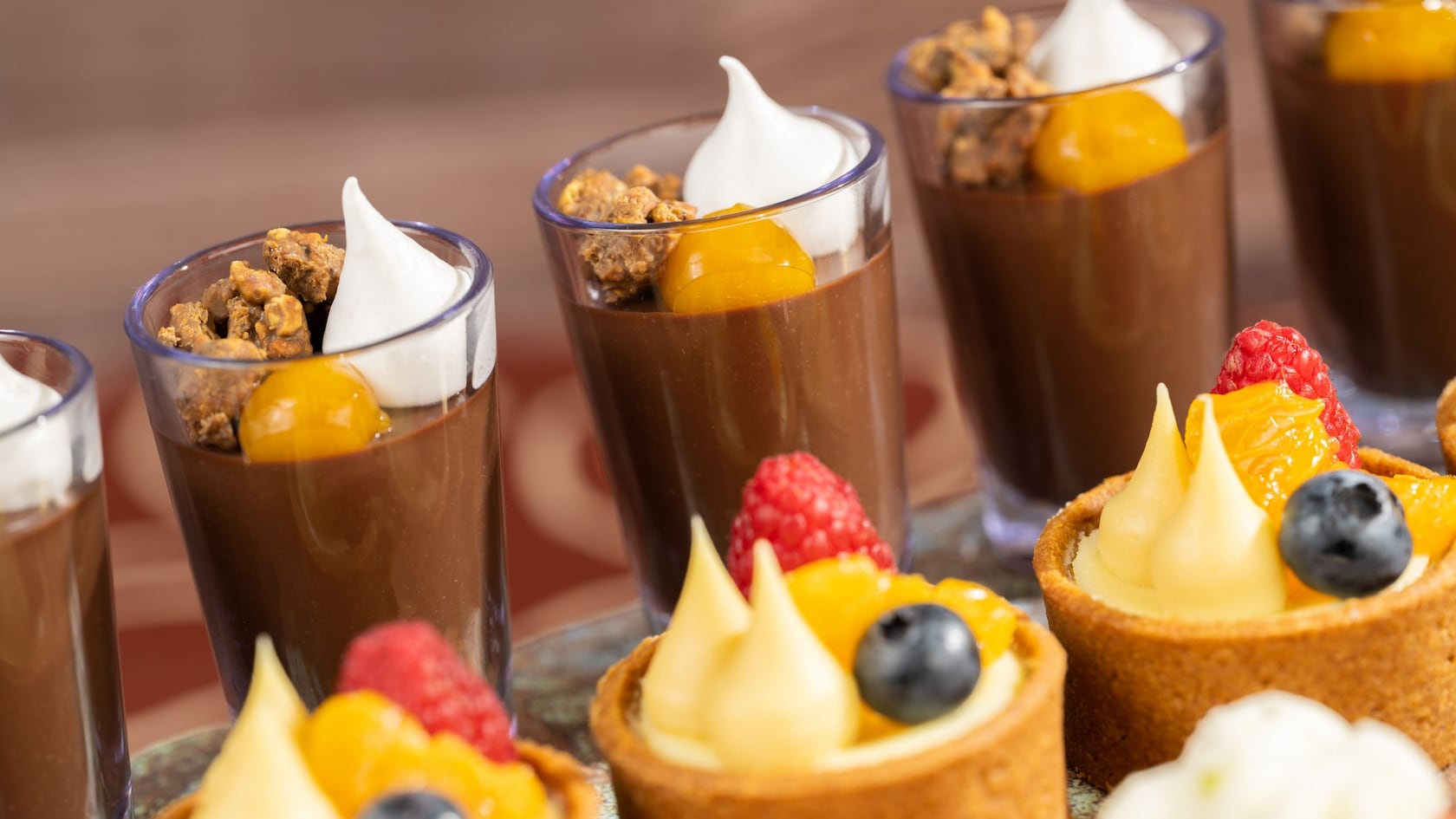 Chocolate mousse shooters and fruit tarts topped with fresh berries