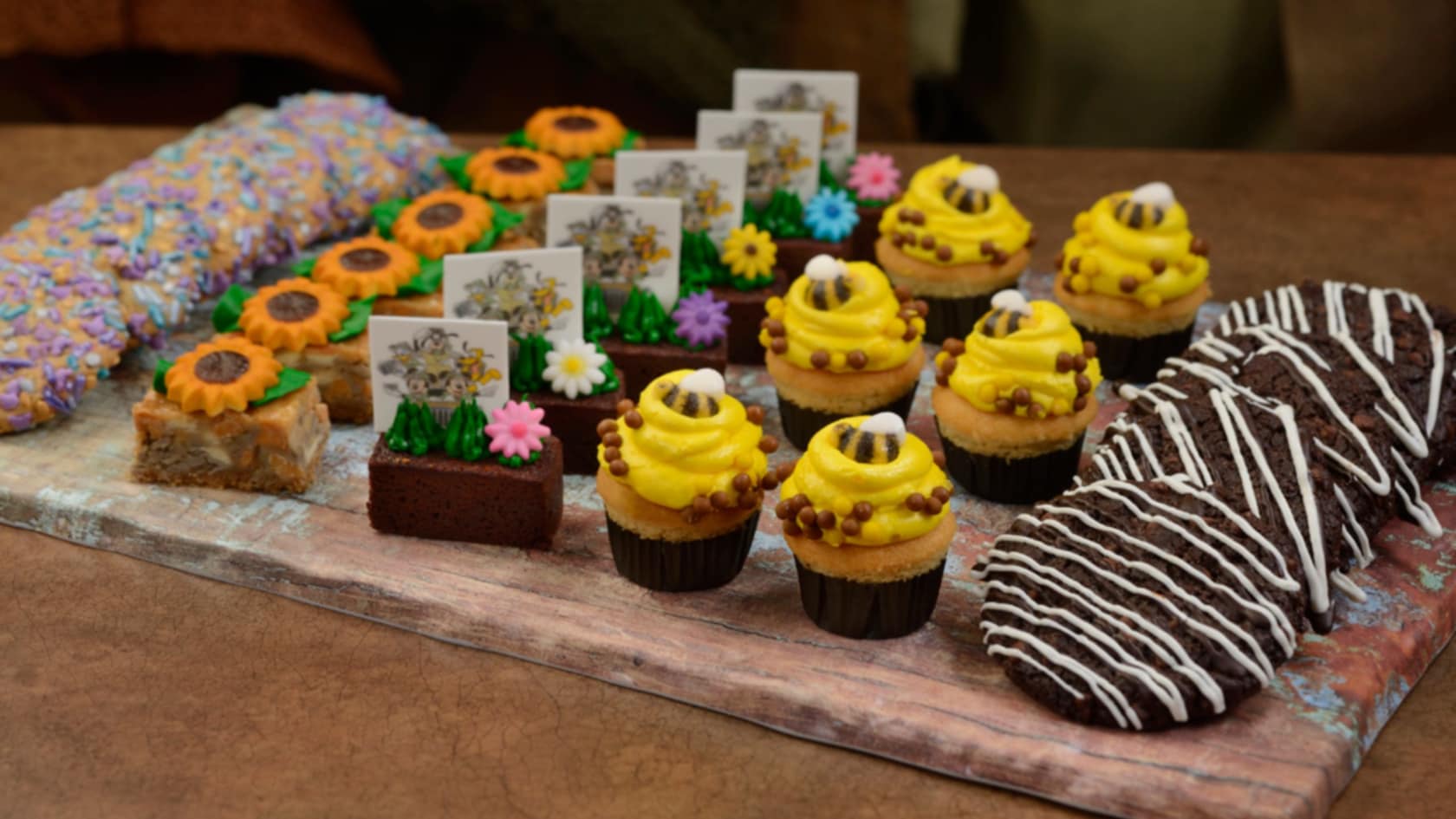 A platter of assorted miniature desserts, including cupcakes, cookies and brownies