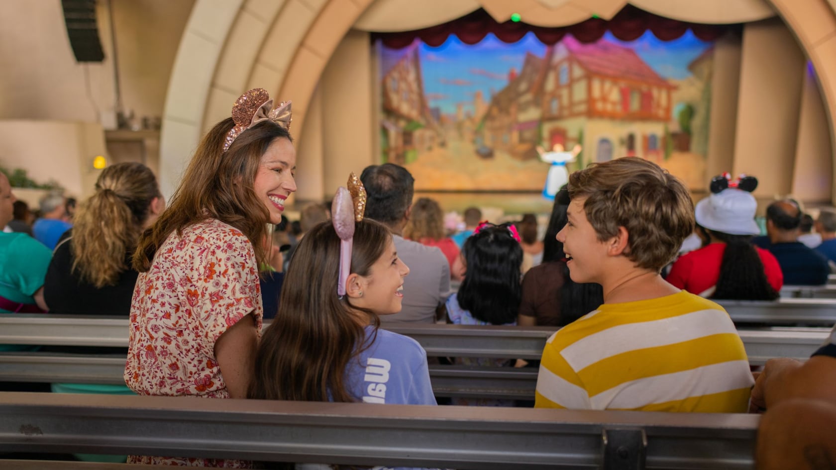 Three guests talking among themselves during the Beauty and the Beast Live on Stage show