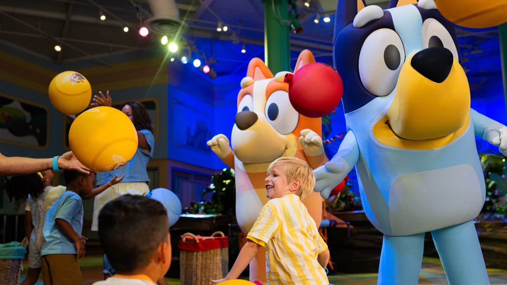 Bluey, Bingo and children play with balloons 