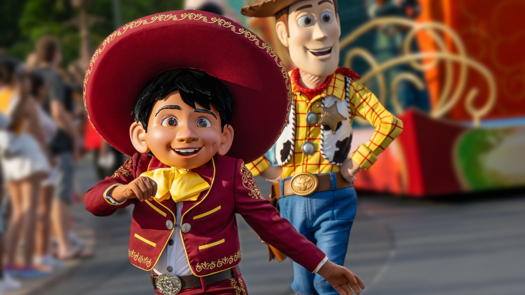 Miguel and Woody walking in the Disney Adventure Friends Cavalcade	