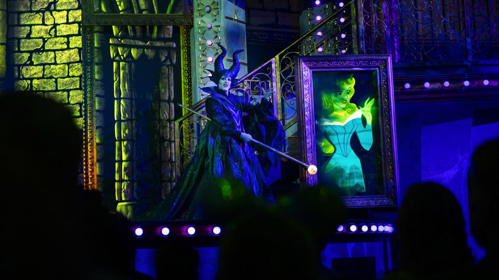 Maleficent on stage with an animated portrait of Aurora during Disney Villains, Unfairly Ever After at Disney’s Hollywood Studios