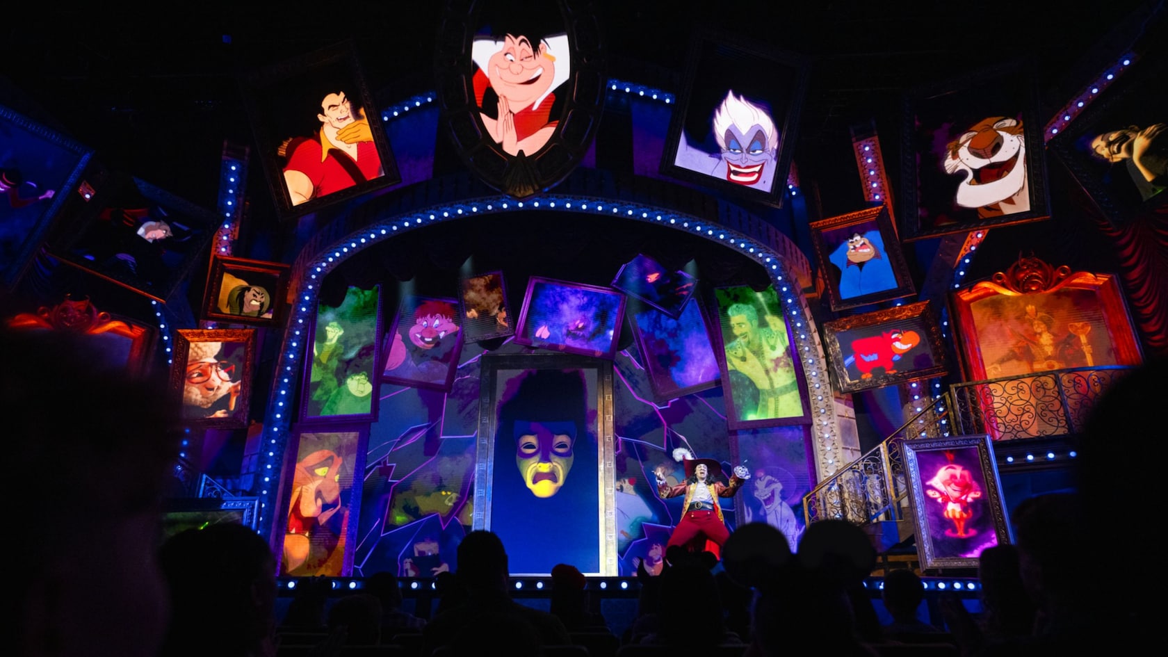 Captain Hook on stage with animated portraits of other Disney villains during Disney Villains, Unfairly Ever After at Disney’s Hollywood Studios