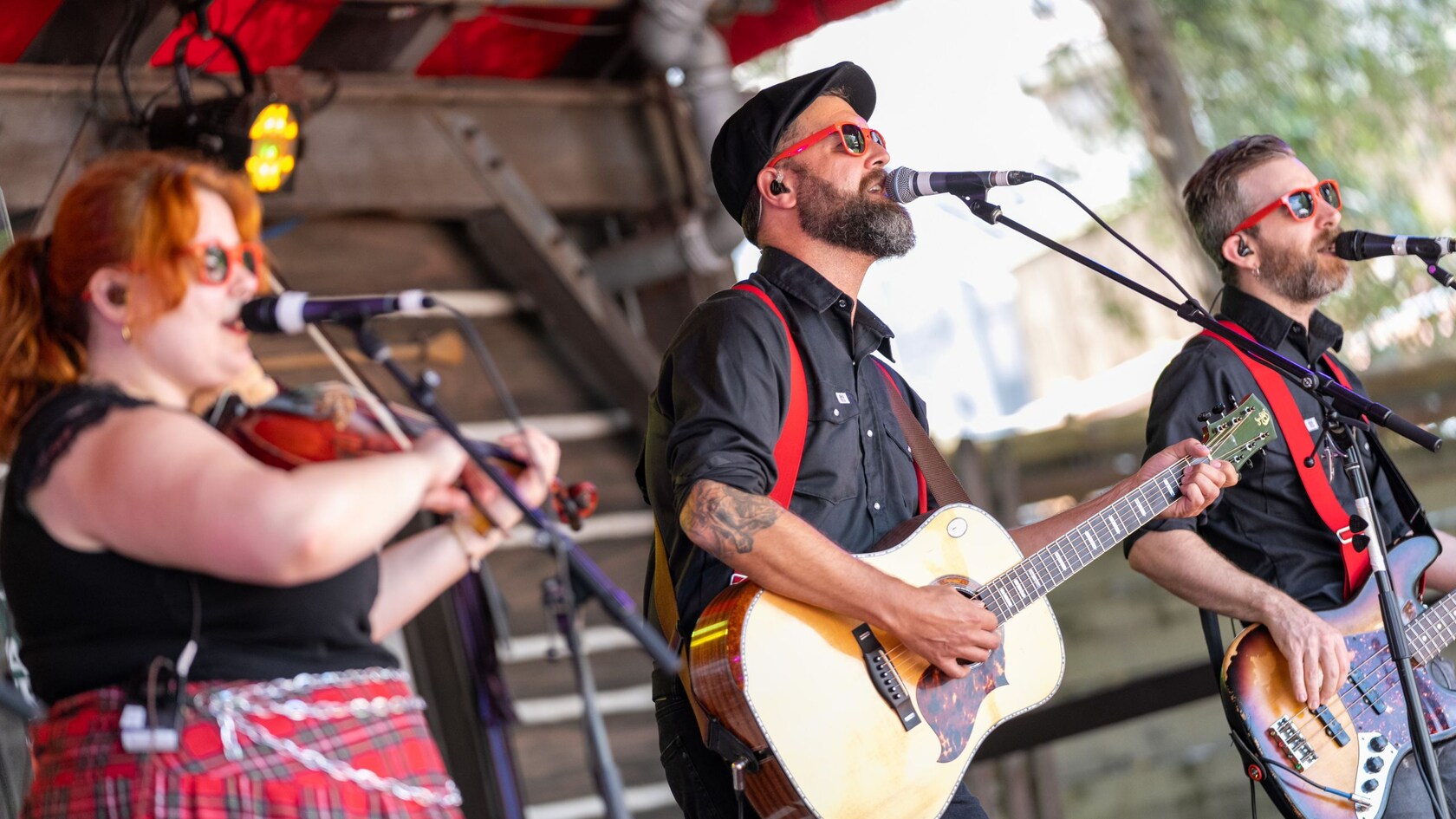The band Cormier and Friends performing on stage with a violin and guitars