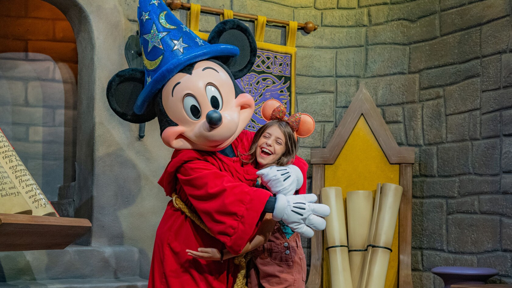 Sorcerer´s Apprentice Mickey Mouse hugging a young Guest in Meet Disney Stars at Red Carpet Dreams