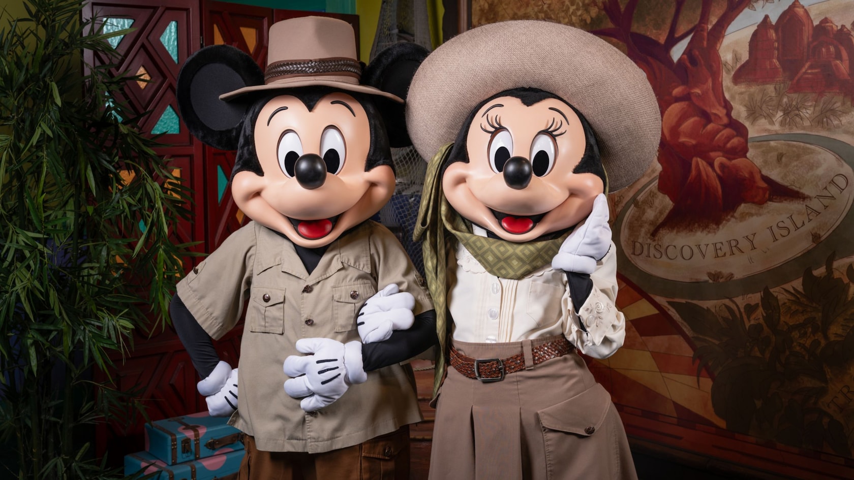 Mickey Mouse and Minnie Mouse standing arm in arm at Discovery Island