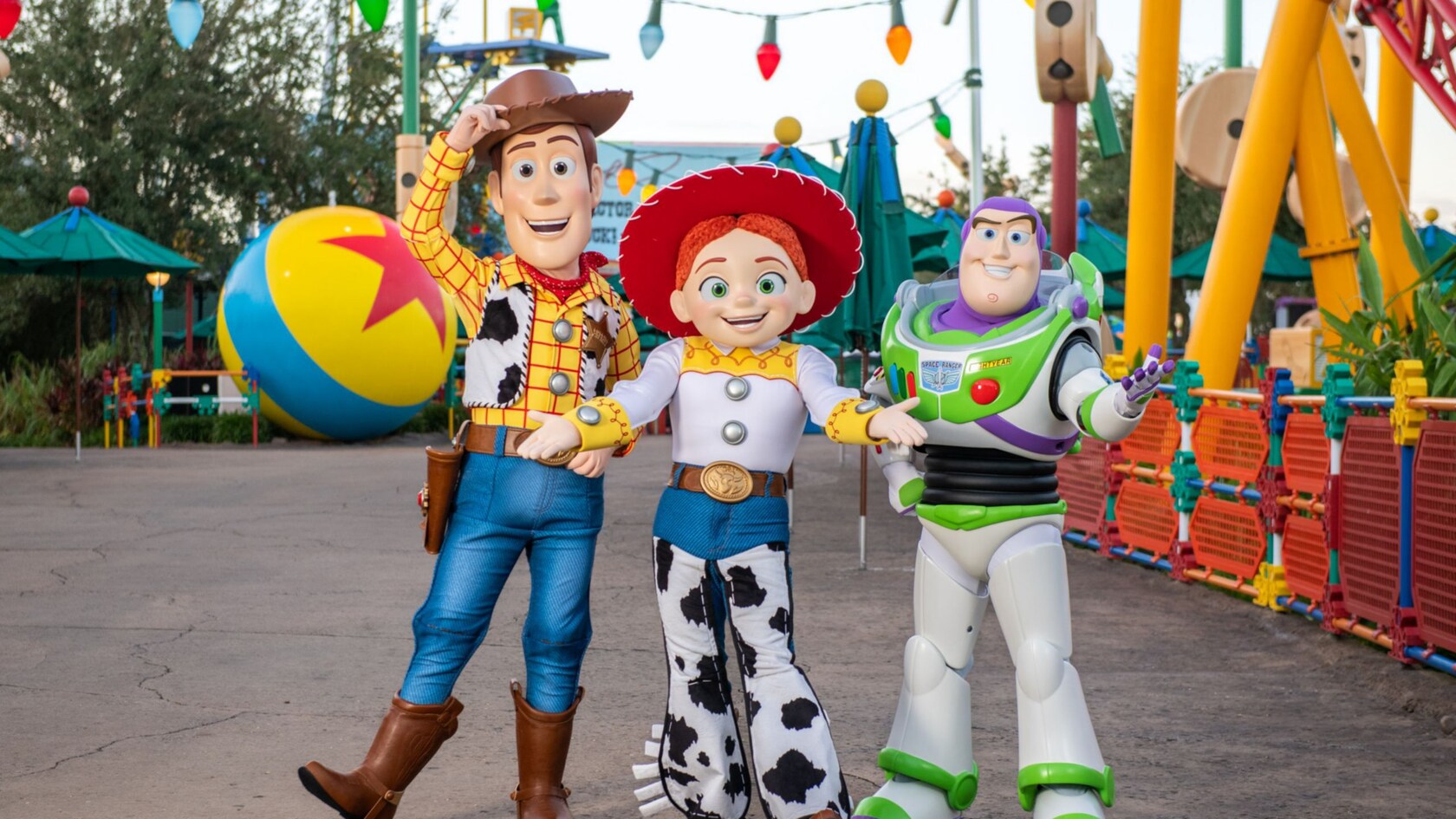 Woody, Jessie and Buzz Lightyear strike a pose in front of Toy Story Land at Disney's Hollywood Studios