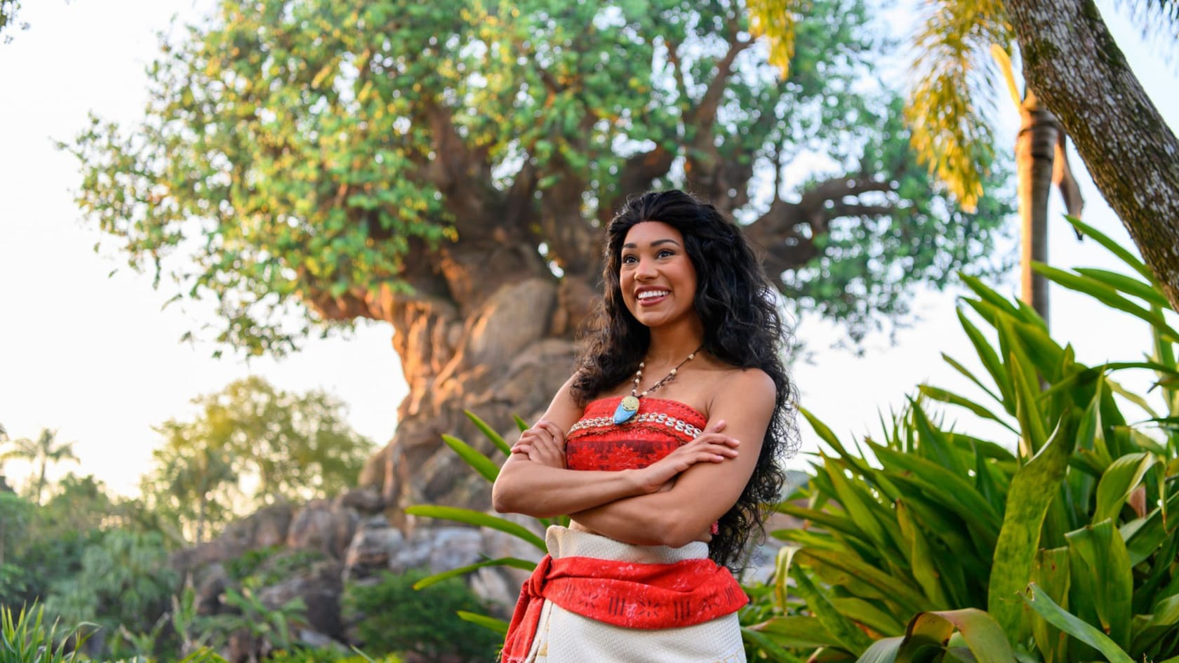 Moana posing with arms crossed in front of the Tree of Life at Disney’s Animal Kingdom theme park