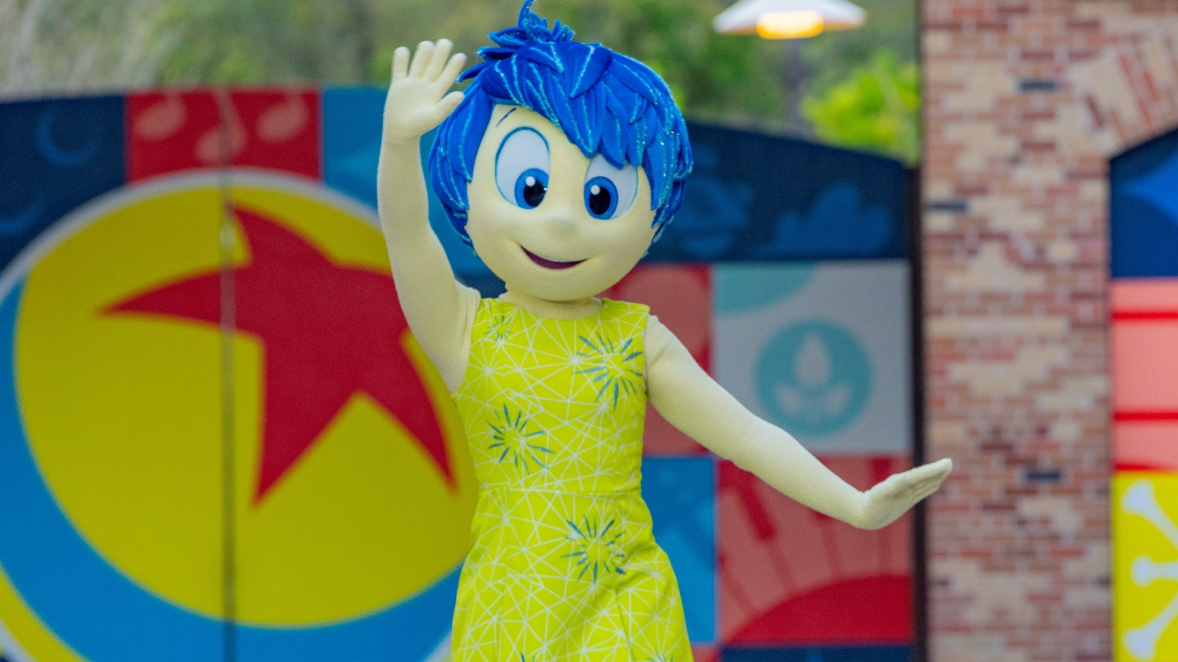 Joy from the Pixar movie Inside Out skipping at Pixar Plaza