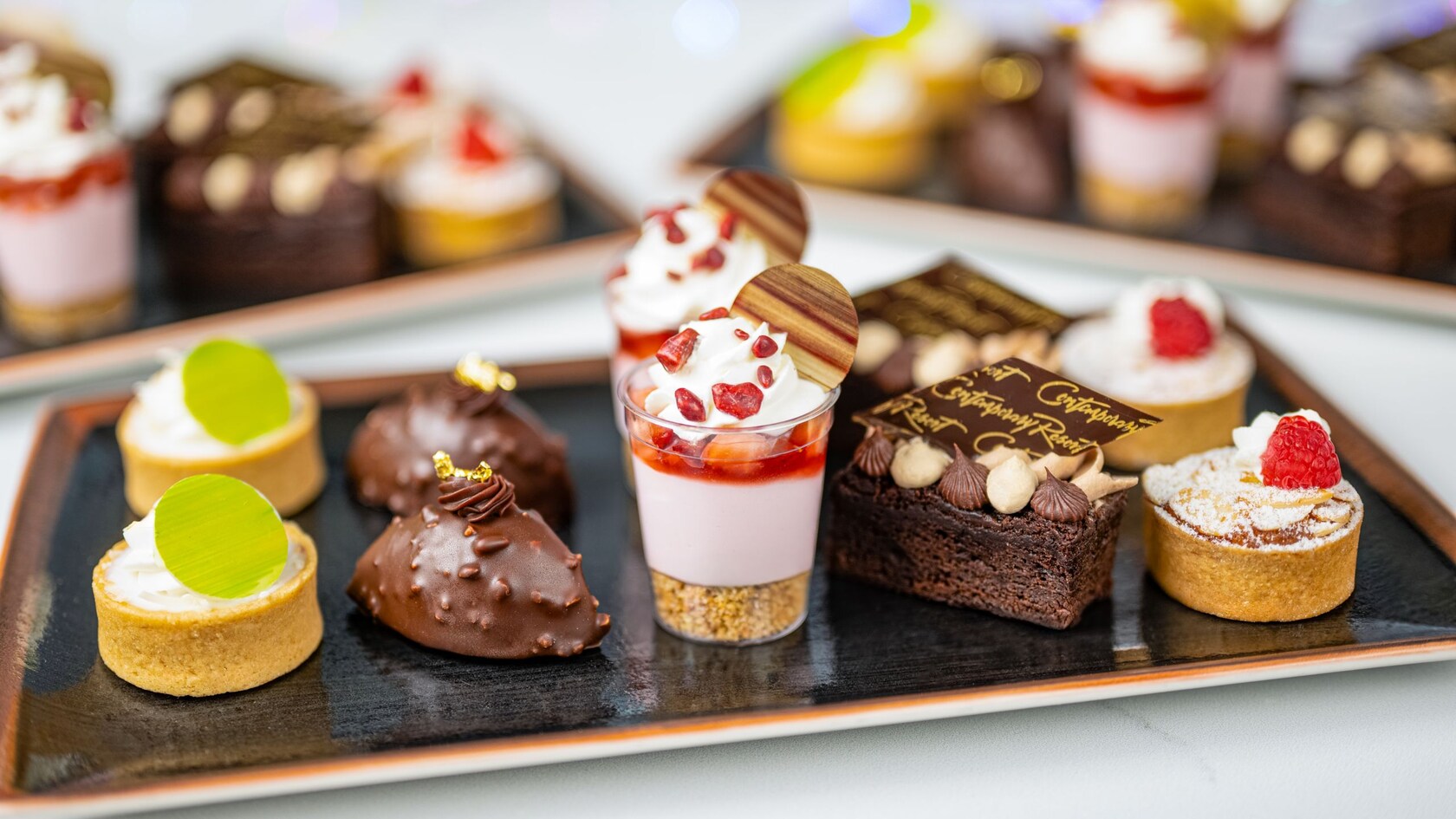 Assorted mini desserts including brownies, tarts and treats arranged on a tray