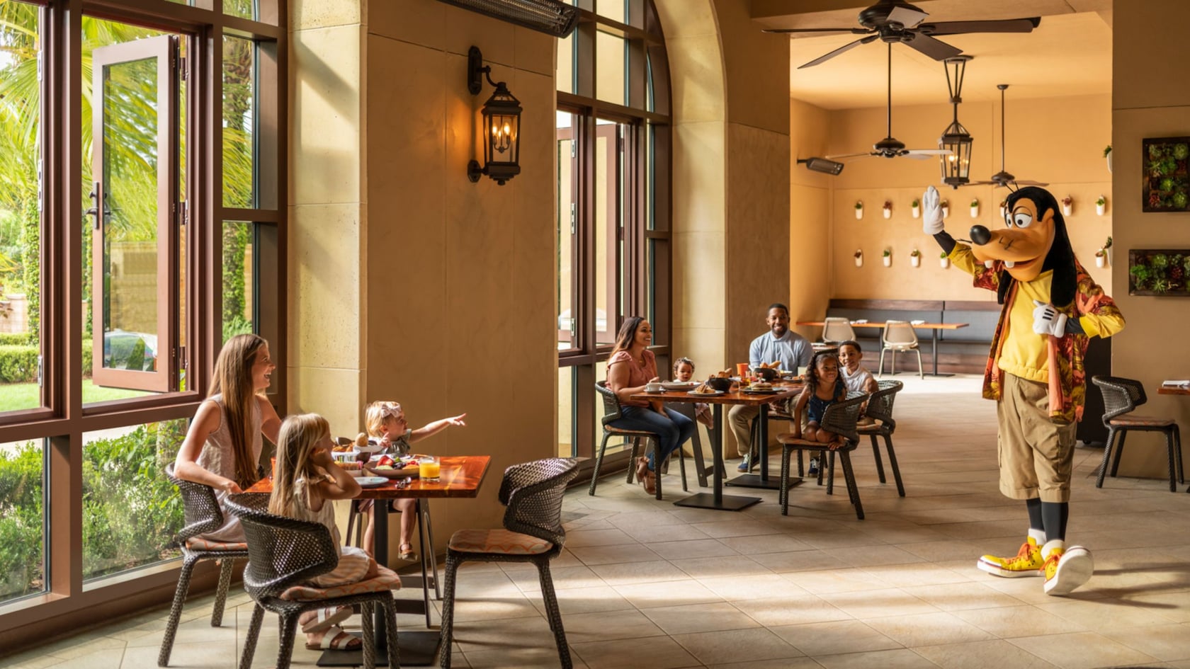 Goofy waving to a family dining in Ravello at the Four Seasons Resort Orlando