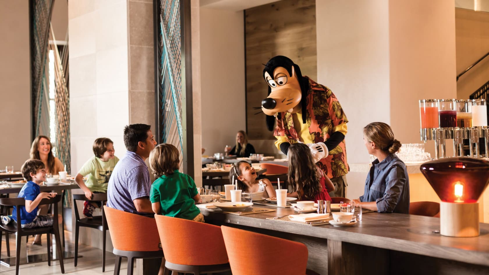 Goofy greets a family at their table during a meal in Ravello at the Four Seasons Resort Orlando