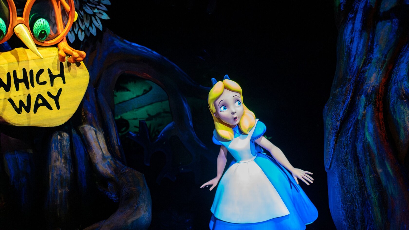 Alice navigating her way through Tulgey Woods at Alice in Wonderland