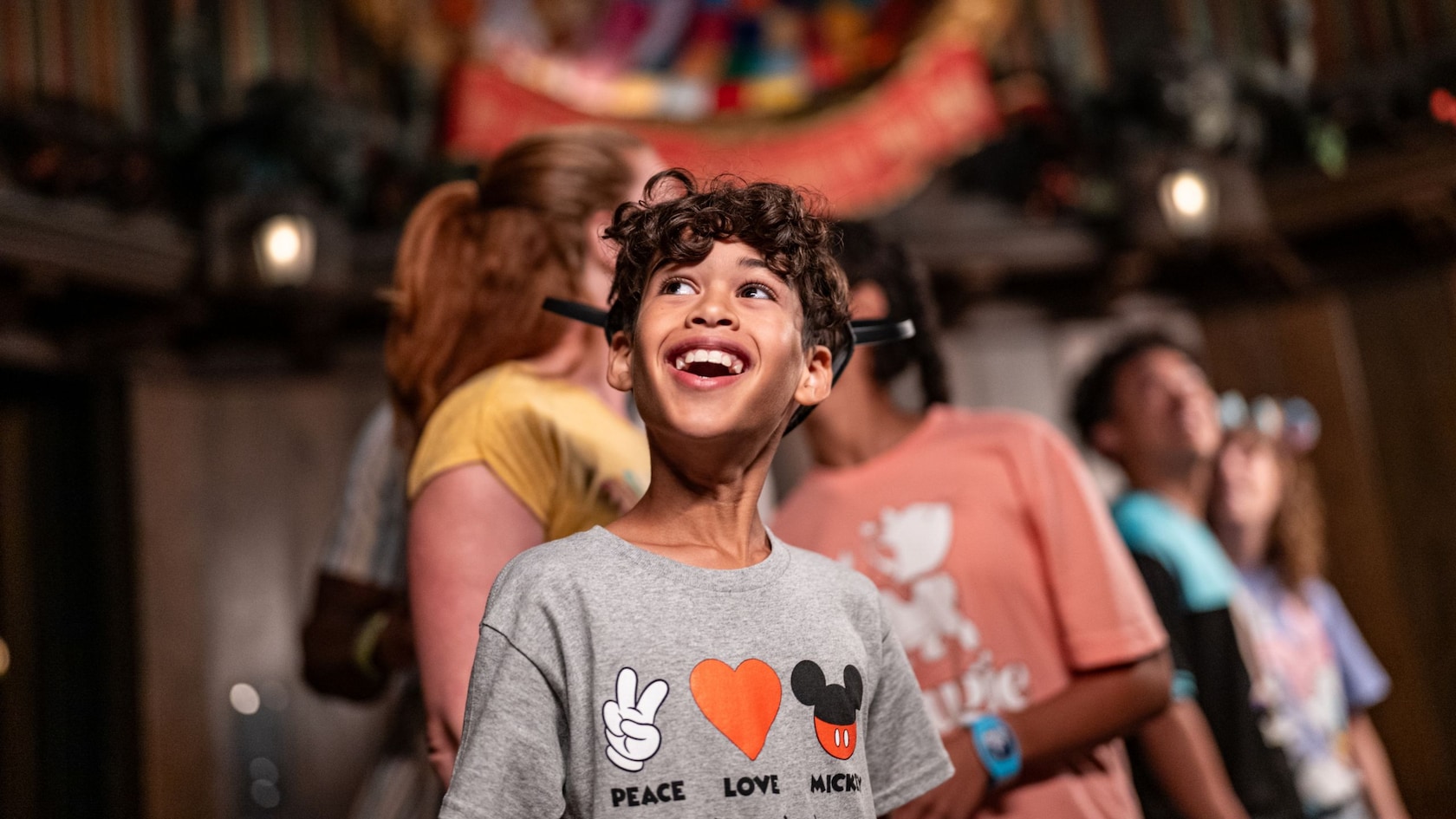 A boy smiling inside of the Portrait Chamber at Haunted Mansion Holiday