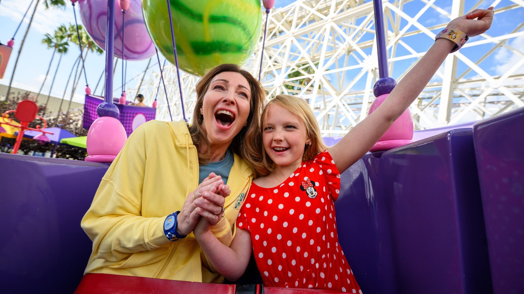 A mother and daughter enjoying their turn at the Inside Out Emotional Whirlwind attraction at Pixar Pier in Disney California Adventure Park