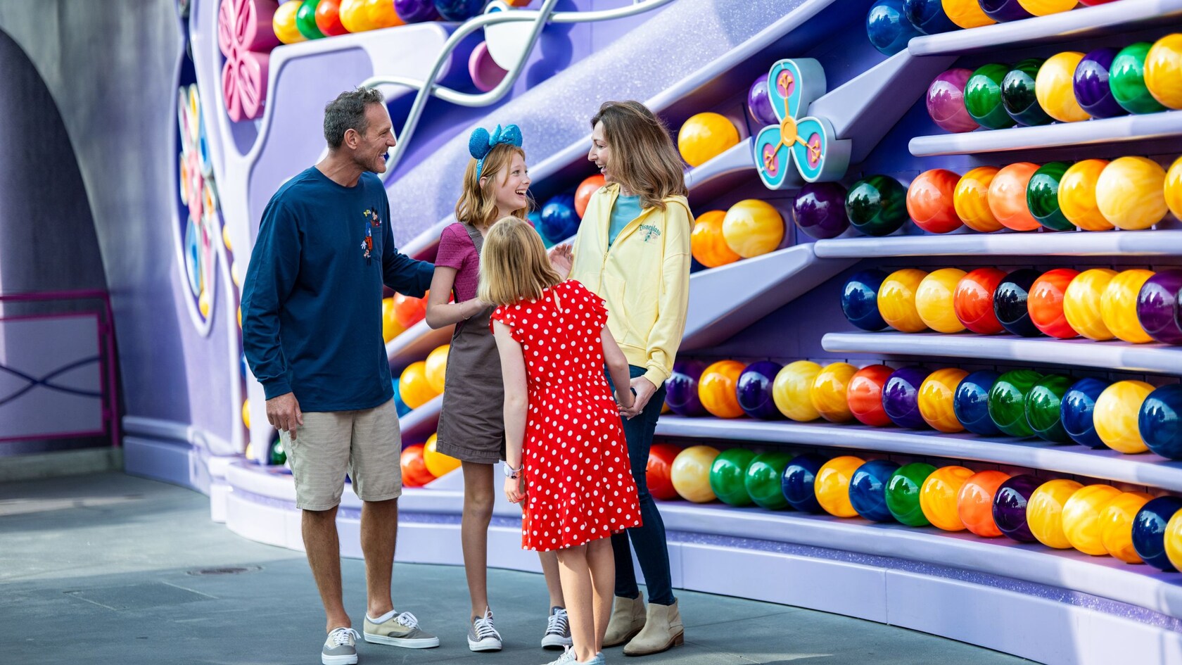 A family of 4 talking among themselves in a section of the Inside Out Emotional Whirlwind attraction at Pixar Pier in Disney California Adventure Park