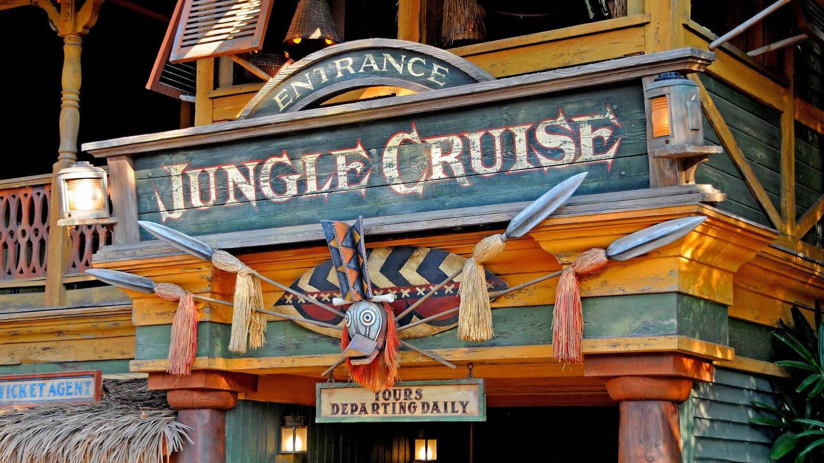 A wooden sign with spears and a carved duck's head identifies the entrance to Jungle Cruise