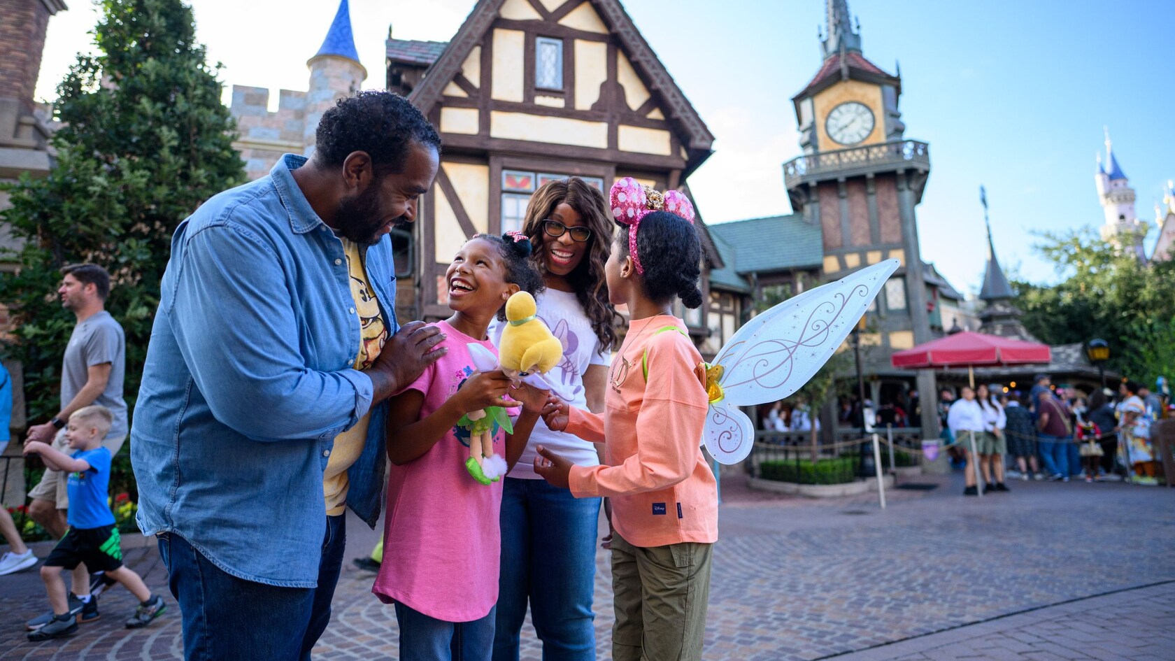 A smiling family of 4 gathered outside Peter Pan’s Flight