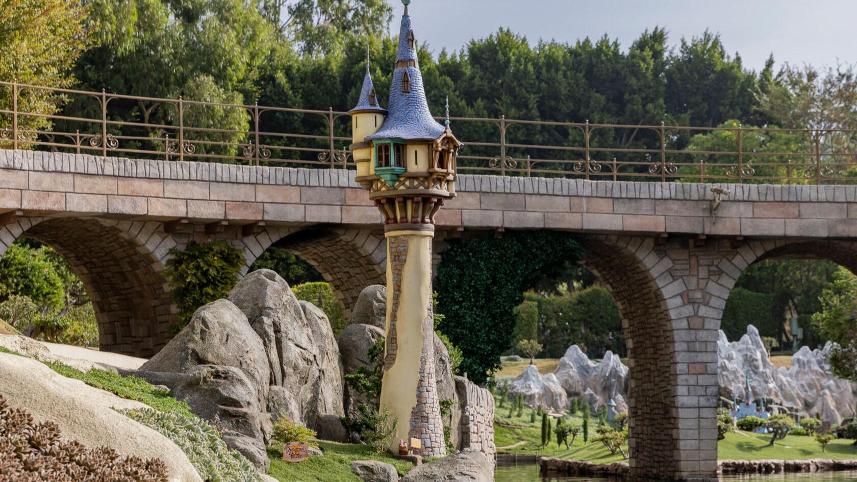 A whimsical tower near a bridge on the Storybook Land Canal Boats attraction at Disneyland Park