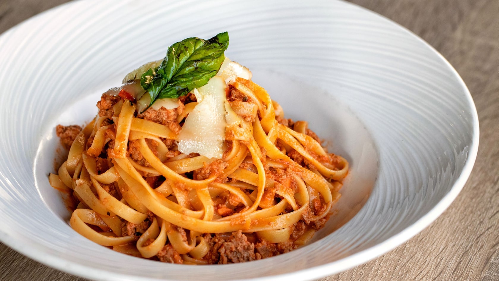 A bowl of pasta with a red sauce