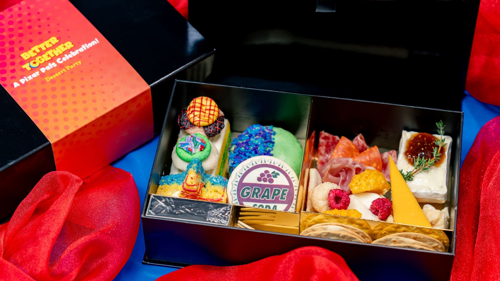 Delicious selection of artisan cheeses, charcuterie,crackers, grape soda macaron, and other treats included in the Better Together Dessert Party
