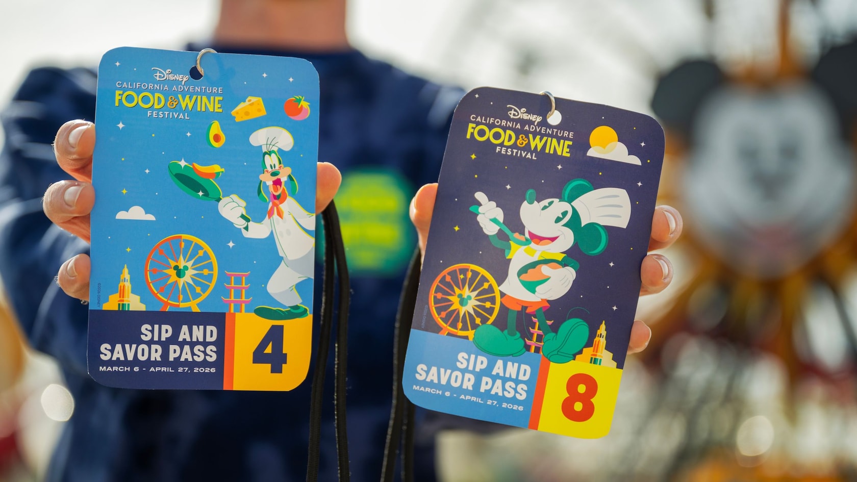 A Guest holding 2 Sip and Savor Passes at Disney California Adventure Food & Wine Festival 2026
