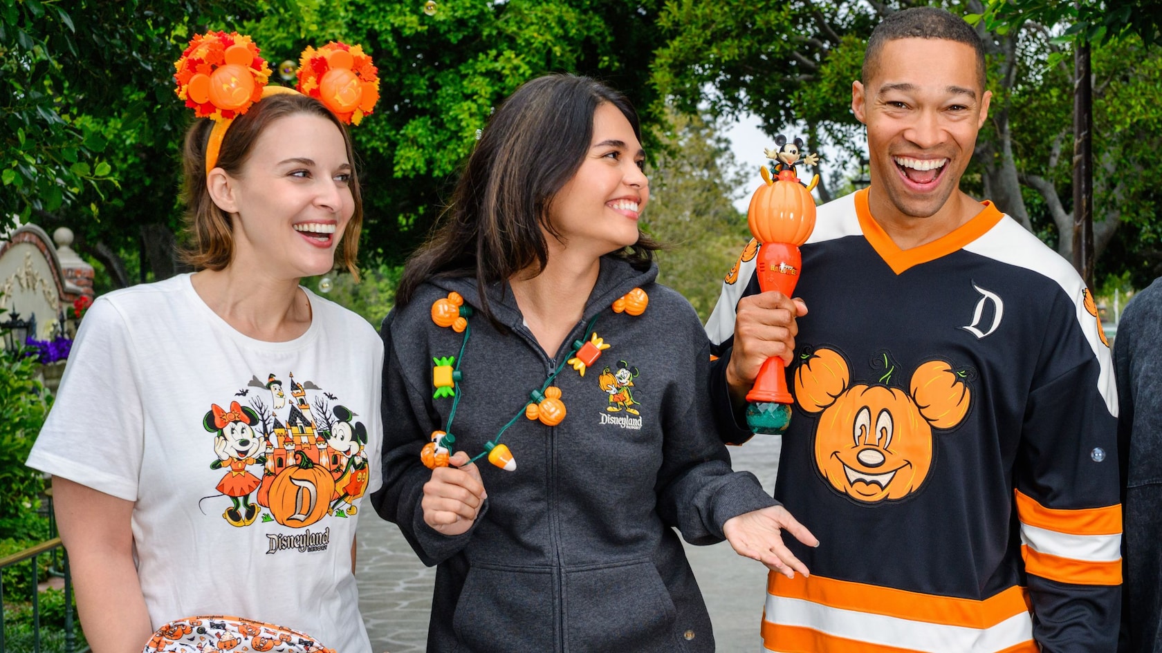 Three adults wear Halloween themed attired at the Disneyland Resort