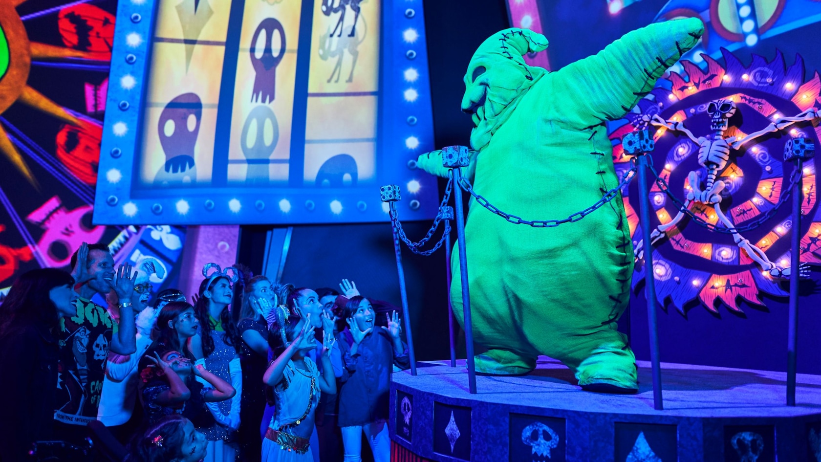 Oogie Boogie on a platform surrounded by Guests at Oogie Boogie Bash A Disney Halloween Party