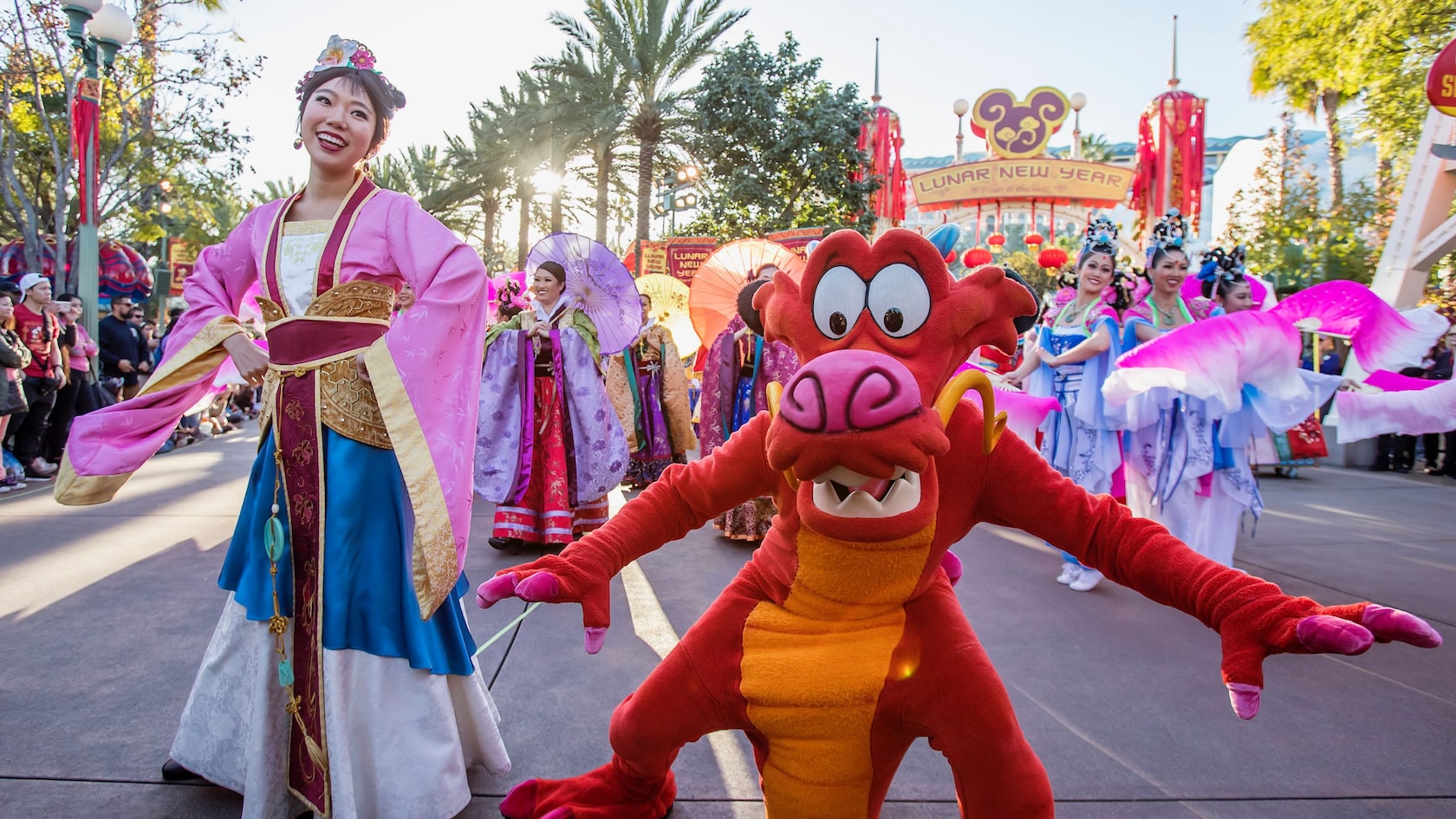 Mulan's New Year Procession with Mulan, costumed performers and a Chinese dragon puppet.