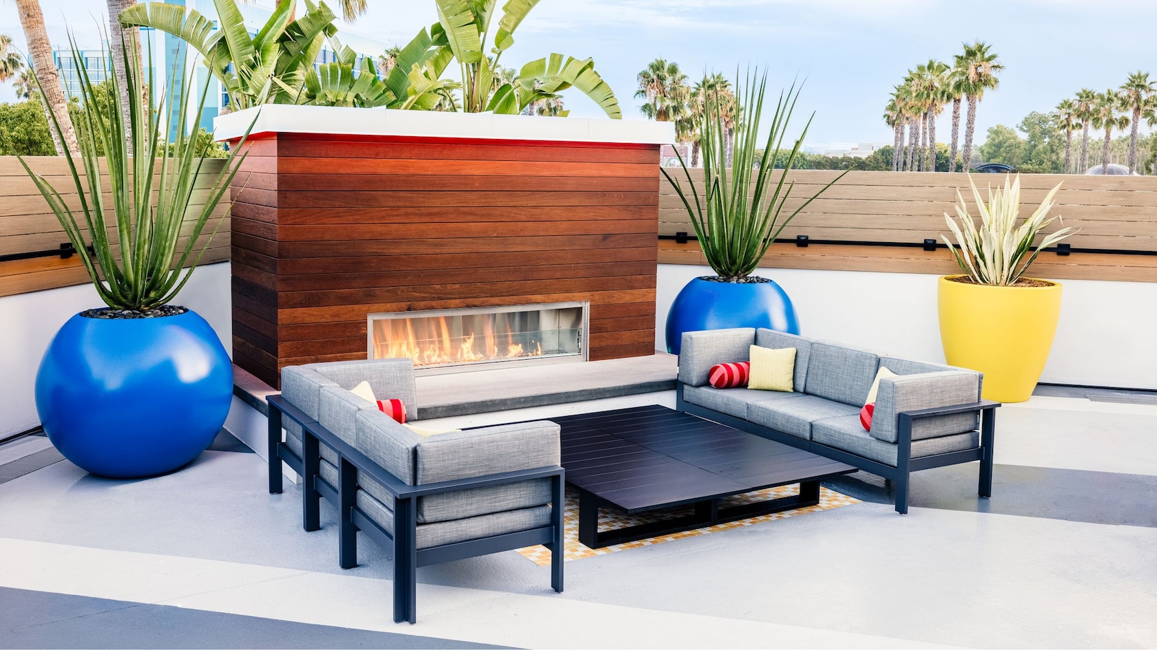 An outdoor sitting area with couches, a coffee table and a fireplace